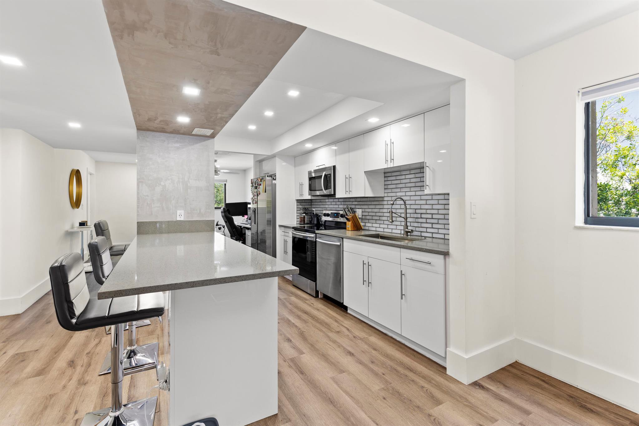 This newly modernized 2/2 second-floor corner unit offers a pleasing blend of elegance and tranquility. Indulge in the serenity of one of the only recreational lakes in South Florida. Imagine enjoying the gentle ripples of the lake and having your own dock space (as available) for moments of relaxation. This is not just a home; it's a lifestyle. Utility room holds washer and dryer. Home has plenty of windows for sunlight and PGT impact glass and impact sliding doors. High end walk-in closet. Stunning cathedral ceiling. Massive master shower, spacious screened/covered patio with additional storage space. Close to beaches, shopping, restaurants, malls, hospitals and all major highways.