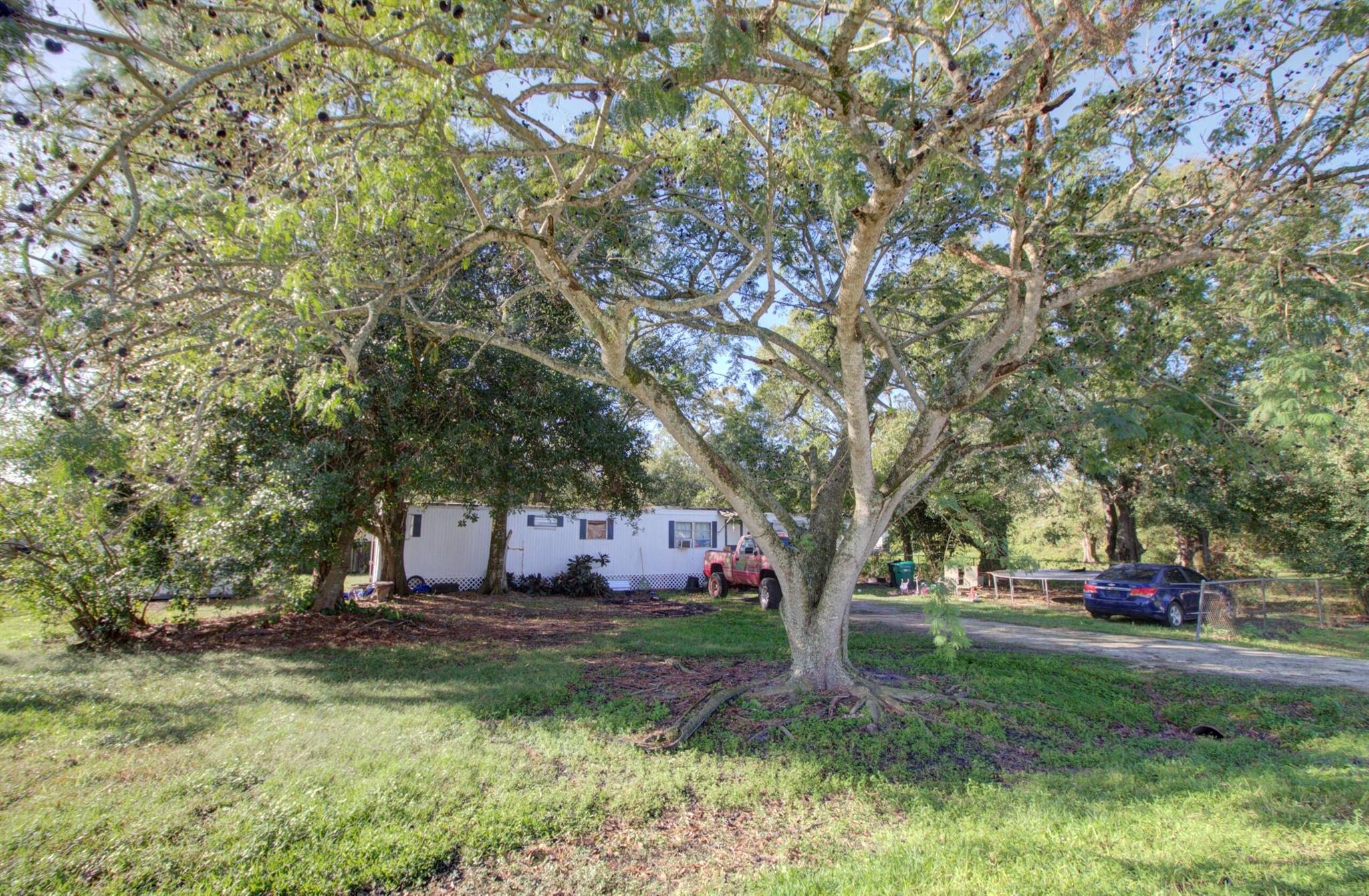 Fixer-upper 2 bed, 1.5 bath single-wide mobile home on a spacious 0.45 lot with easy access to Saint Lucie County via Highway 70. Currently leased for $1,000/month, offering investment potential. Includes a second structure on the lot that may need removal. Great opportunity for investors!
