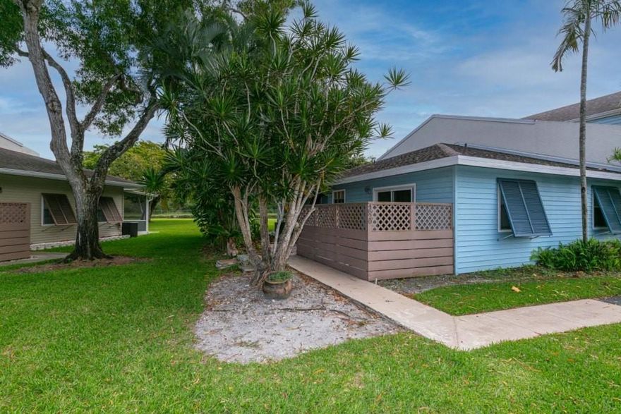 Beautiful & Remodeled 2 Bedroom, 2 Bath Villa, Corner Unit.  Remodeled Kitchen w/Granite Counters, Maple Wood Cabinets w/Pullout drawers and Stainless Steel Appliances.   Renovated Baths, New Full Size Washer & Dryer 2022, Tiled Living Areas, Partial Hurricane Protection w/3 Impact Resistant Doors, Bahama Shutters.  Master Suite has Walk in Closet & Slider to Private Fenced Patio.  Rear Screened Patio has Large Yard and Tremendous Lawn View to Canal w/No Rear Neighbors.  2 Reserved Parking Spaces Directly in Front of Villa. All Ages Community has Heated Pool, Tennis, BBQ/Picnic Area, Sauna, Hot Tub, Exercise Room, Canal w/Dock.  Low HOA Includes All Amenities, Roof Maintenance & Reserves.  Pets OK.  This One Will Go Fast.  HURRY!!!