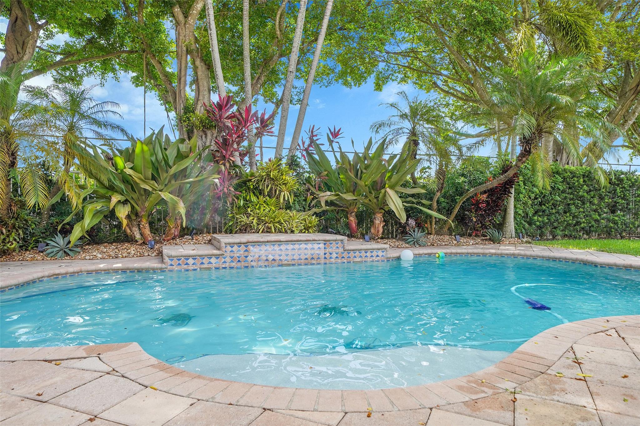 Welcome to this large 2 story pool home in gated Isles at Weston—bicycle to Cypress Bay High School, Falcon Cove Middle & Manatee Bay Elementary, great amenities, & resort-style living. 1st floor full bed & bath, ideal for guests or in-laws. The large kitchen features wood cabinets & a walk-in pantry, open to family room overlooking the heated pool with waterfall. Enjoy a fenced patio & covered terrace with no rear neighbors—great for relaxing or entertaining.
Neutral tile in living areas, 3-car garage, and new luxury vinyl floors on the staircase and entire second floor add style and function. Upstairs, the primary suite offers dual sinks, soaking tub, & separate shower.
Sellers can accommodate a fast close