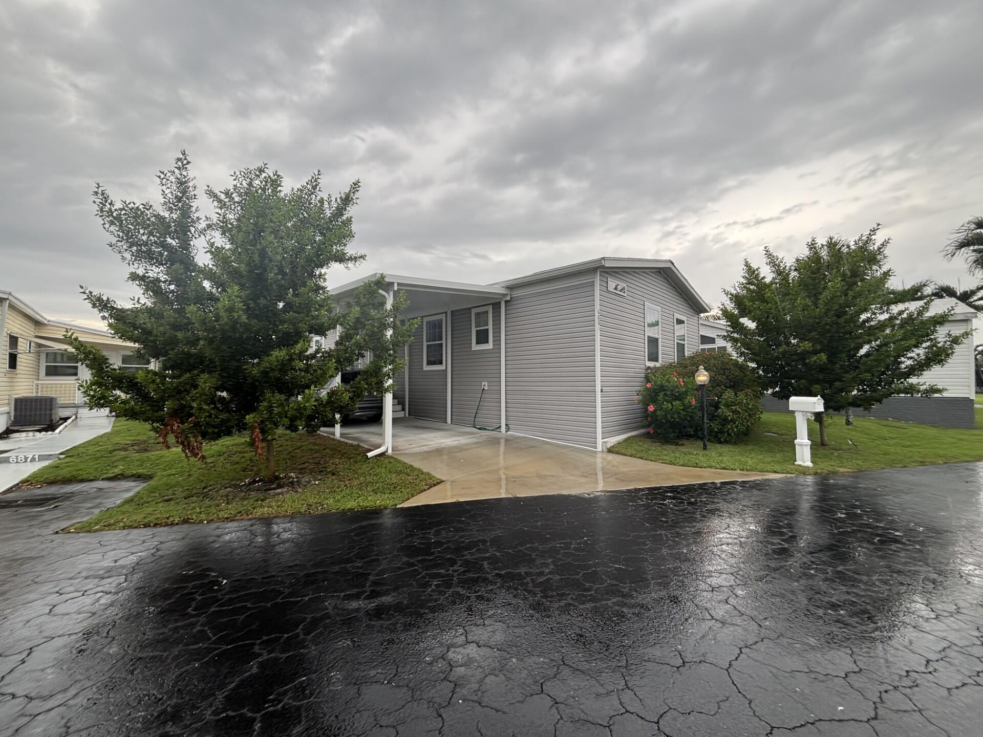 DON'T MISS THE OPPORTUNITY TO SEE THIS BEAUTIFUL HOME WITH 3 BEDROOMS, 2 BATHS, LARGE OPEN PORCH WITH WATER VIEW, OFFERING GREAT COMFORT AND SERENITY. IT HAS ALL THE SPACE FOR RELAXATION AND DELIGHTFUL. PERFECT TO SPEND TIME WITH FAMILY AND FRIENDS. HOME WAS BUILT IN 2023 WITH THE NEW HURRICANE STANDARD, HURRICANE IMPACT WINDOWS, 9 FOOT CEILING, TEXTURE WALLS, UPGRATED EXAUST SYSTEM-NO MOLD. CROWN MOLDING THOUGHOUT THE HOME AND ROOF IS TIEDDOWN.HOME LOCATED IN A 55+ COMMUNITY, ONLY A FEW MILES FROM THE DESIREBLE DEERFIELD BEACH, MAJOR AIRPORTS, HOSPITAL AND MORE. LOT RENTAL $111.00 MONTHY, INCLUDING WATER, SEWER AND TAXES.