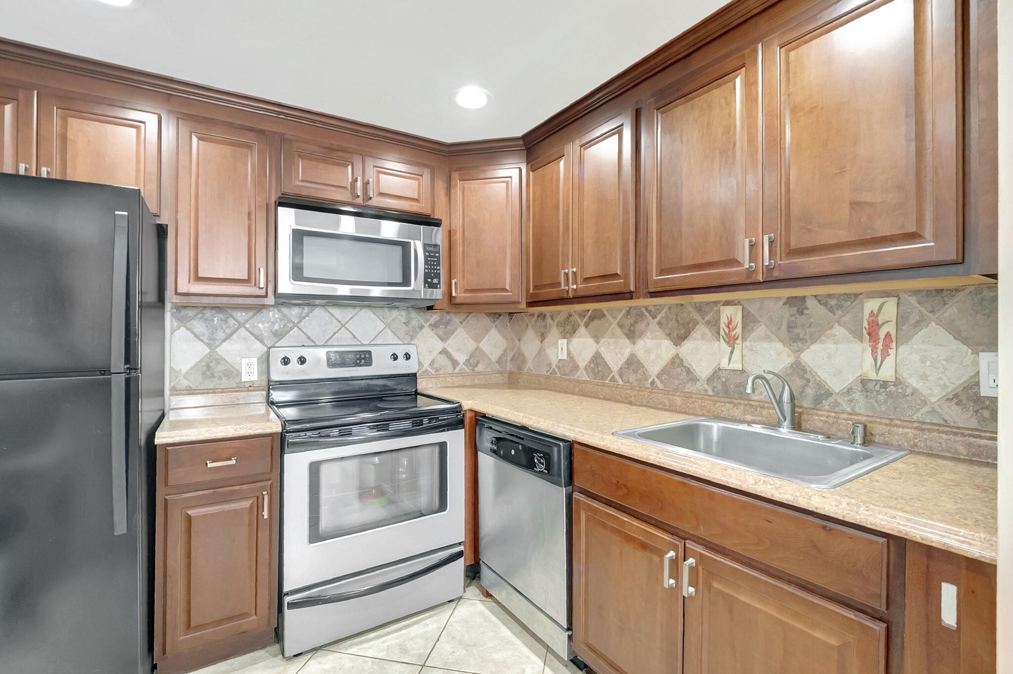 Newly priced, motivated seller will reimburse buyers $1800. capital contribution w/full priced offer, at closing! Pride of ownership is evident from the moment you enter into this remodeled 1st floor corner 1/BR 1.5/BA condo. Condo features: New AC Nov. 2023, Newer Window wall AC unit in Lanai, Neutral tile flooring throughout, Completely updated bathrooms 2020, master bathroom has updated shower stall, Open concept Kitchen updated 2020, newer appliances, refrigerator 2019 w/ice maker, paddle fans 2020, accordion shutters on windows, new raised panel doors, newer full size washer and dryer, window treatments 2020. Close to clubhouse and Jog Road entrance, Make this updated corner condo your new piece of paradise.