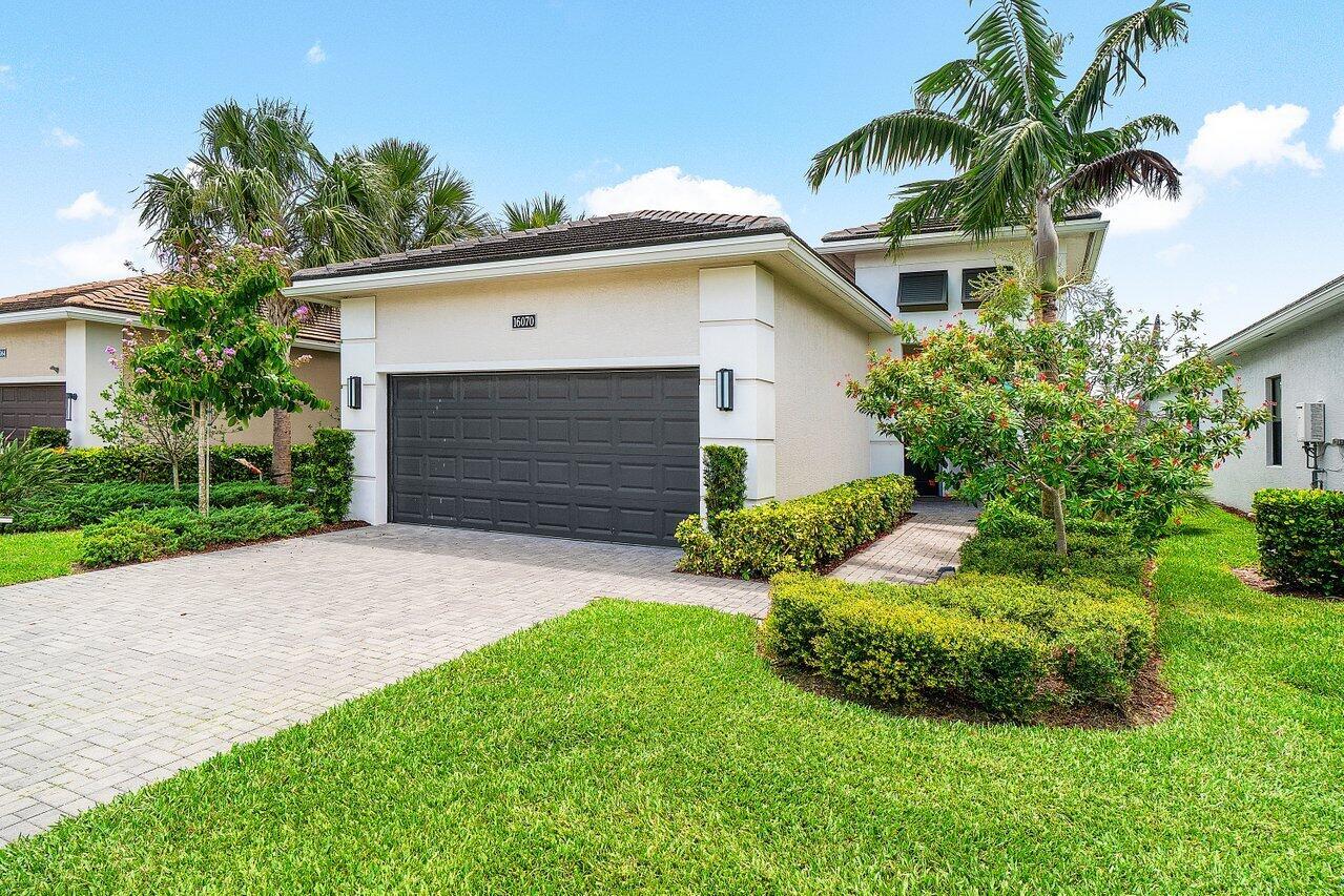 Don't miss out on this luxuriously appointed home in the highly sought-after Cresswind of Palm Beach +55 community. This 2 Bedroom, 2 Bathroom plus Den Lido model will not disappoint. Positioned on the perfect lot, this home boasts breathtaking and unobstructed water views which can be clearly seen from the comfort of the patio while peering through the picturesque, panoramic view panel screen. Inside you will find an upgraded, modern decor throughout. The kitchen is highly functional as well as beautiful, including soft-close cabinets, double ovens, a gas stove, large pantry and an eat-in table with great natural light exposure. This home has plenty of storage with double walk in closets in the primary suite and a 2 car garage. Cresswind offers wonderful amenities to lead an active