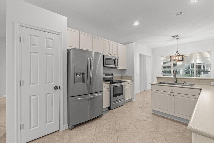 Welcome to 118 Lancaster Road, a spacious 3-bedroom, 2.5-bath townhouse located in the desirable Carriage Pointe community of Boynton Beach. Offering an impressive 2,209 square feet under air, this residence features a bright, open-concept floor plan designed for comfortable everyday living and effortless entertaining. The home showcases stainless steel appliances, generous kitchen storage, expansive living and dining areas, and no carpet throughout, with a tasteful combination of tile and luxury vinyl flooring. Upstairs, the spacious primary suite offers a refined retreat complete with a walk-in closet and an en-suite bath featuring dual vanities, a soaking tub, and a separate shower. A versatile loft provides the perfect flex space for a home office, media room, playroom, or additional lounge area, and is complemented by two well-appointed guest bedrooms. Additional features include fresh paint, a private outdoor patio, a 2-car garage, and an extended 2-car driveway. Carriage Pointe offers desirable amenities including a community pool, cable, tot lot, sidewalks, and a low HOA. Ideally situated near Caloosa Park, I-95, beautiful beaches, and the renowned dining, shopping, and entertainment of Downtown Delray Beach, this home offers the perfect blend of space, comfort, convenience, and South Florida lifestyle.