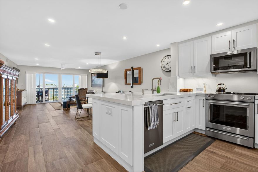 WOW Absolutely stunning! Completely remodeled within the last 5 years with high quality upgrades throughout. Full impact protection, Lutron lighting, custom closets, high end appliances, white custom kitchen cabinetry with under cabinet lighting, smooth ceilings, wine fridge & quartz Calacatta countertops with full backsplash. No detail spared with 6" baseboards, recessed lighting, new electrical panel & spa inspired bathrooms. Stunning home that must be seen to appreciate. Enjoy a huge patio capturing refreshing ocean breezes. Beach & shopping just around the corner. All assessments paid in full. Try duplicating these finishes today at a much higher cost. Perfect for buyers who appreciate true luxury living. Move in ready, MUST See today!