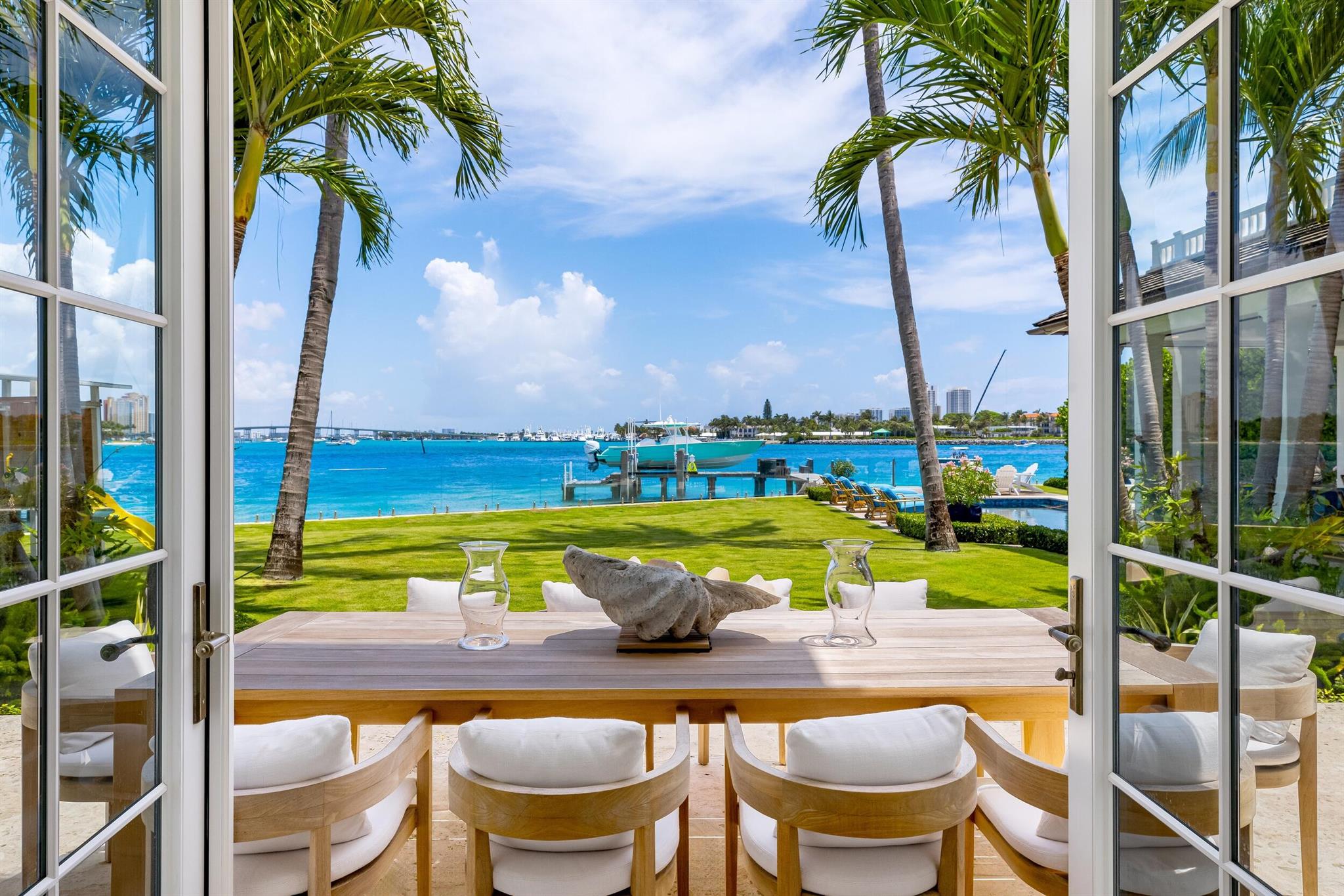 Welcome to 1610 N Ocean Blvd, a rare opportunity to own a spectacular 6-bedroom, 7.2-bathroom waterfront residence, masterfully built in 2018. With breathtaking views from all principal rooms, this elegant estate offers the perfect blend of British West indies elegance and contemporary refinement.A long private, gated driveway leads to a grand, beautifully landscaped courtyard entrance - providing the feeling of entering a lush tropical compound. The iconic entryway leads into an expansive formal living room with a stately fireplace, with Bahamian blue water colors conveniently positioned as the perfect backdrop. The gourmet chef's kitchen is a culinary dream, featuring a large center island and seamlessly flowing into the spacious family room, ideal for relaxed entertaining.