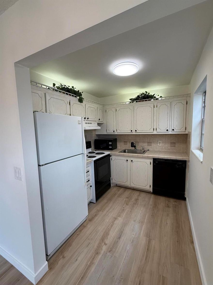 This charming 2-bedroom, second-floor corner unit offers comfort, convenience, and beautiful lake views in a gated 55+ community. The home features all new LVT flooring throughout and updated bathrooms, giving the space a modern and refreshed feel. Enjoy the peaceful lake views from your private balcony, perfect for relaxing and unwinding. Residents have access to resort-style amenities, including a 1,000-seat theater for shows and movies, indoor and outdoor pools, a courtesy bus, and more. All of this is conveniently located near PBI Airport, great restaurants, shopping, and beautiful beaches.