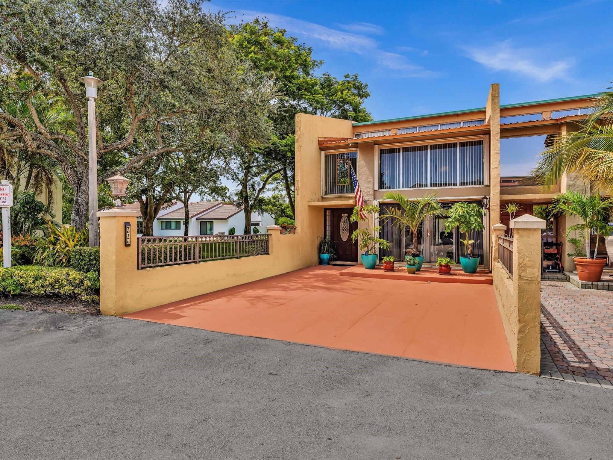Fabulous 3BR, 2.5BA lakefront townhome in Jacaranda Country Club in the heart of Plantation! This end unit is the largest model at 2,120 sq. ft. & has a private screened courtyard patio with tropical water views, no neighbor on one side, and additional green space. Enjoy lake views from both primary bedrooms—one located on the first floor, and another upstairs with its own balcony. Highlights include a remodeled kitchen, updated bath vanities, vaulted ceilings, walk-in closets, and a newer roof. Upstairs features two bedrooms with a shared bathroom and separate vanity areas. Accordion shutters, private driveway, & a location just minutes from top shopping, dining, major highways & the airport. Association requires 20% down & a 650+ credit score. A beautiful place to call home!