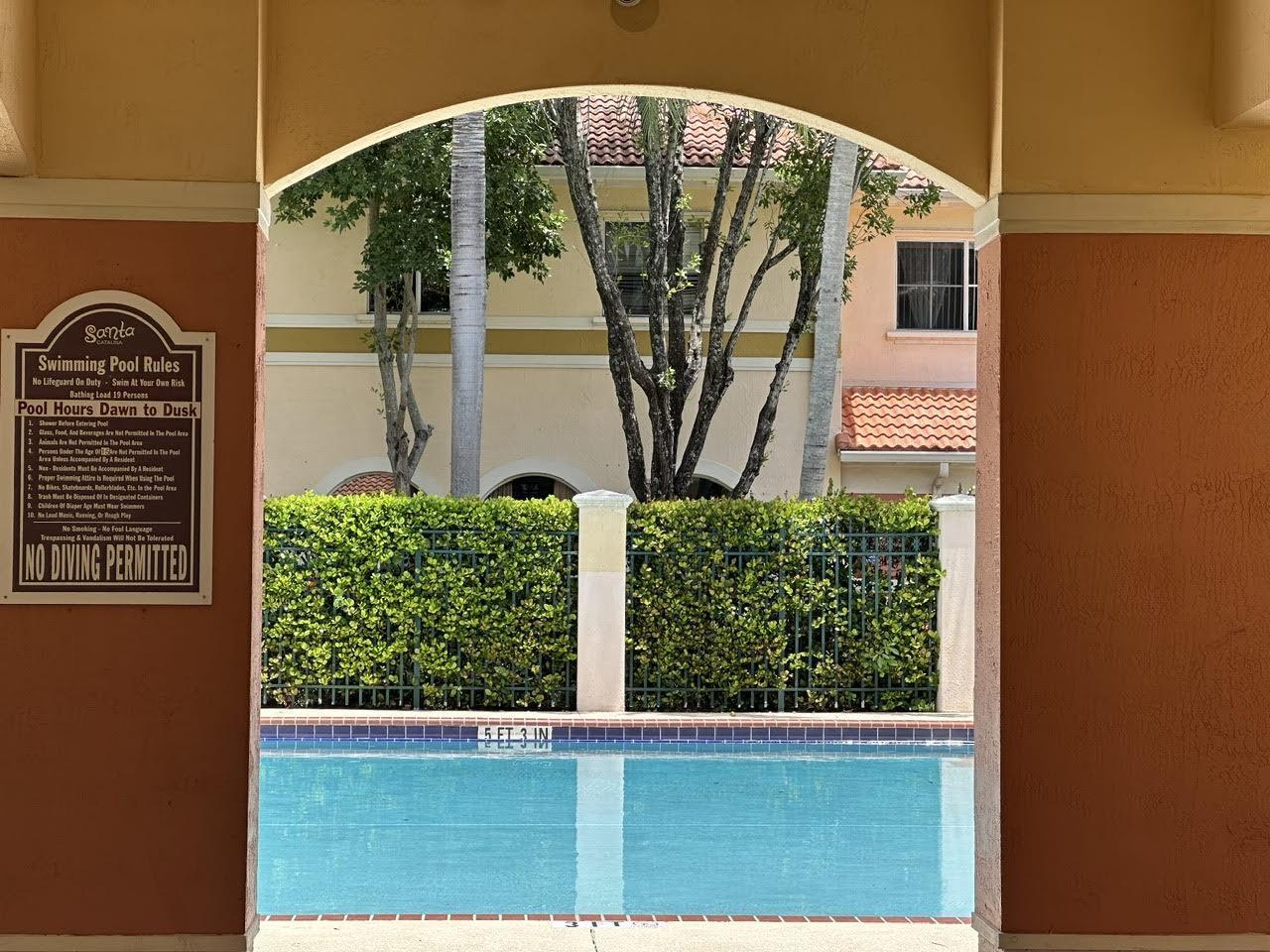 Features include an open living/dining area, modern kitchen with breakfast bar, and two master suites with walk-in closets. Tile and laminate flooring throughout plus in-unit washer/dryer. Community amenities include pool, playground, and assigned parking. Conveniently located near highways, shopping, dining, and just minutes from Fort Lauderdale beaches.