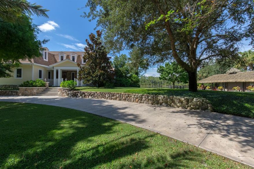 This Colonial-style luxury estate is located in the private, gated equestrian community of Homeland. It is situated on a south-facing lot offering a private and secluded setting with unobstructed sunrise and sunset vistas year round. The home has been through an extensive renovation and will be sure to impress even the most privileged of your guests. Encompassing the gated 5-acre property is the 10,913 square foot residence, an expansive tiki hut lounge, and an amazing resort-style backyard and pool area. The home features 6 bedrooms, 6 full and 2 half bathrooms, and a 3 and a half-car garage.