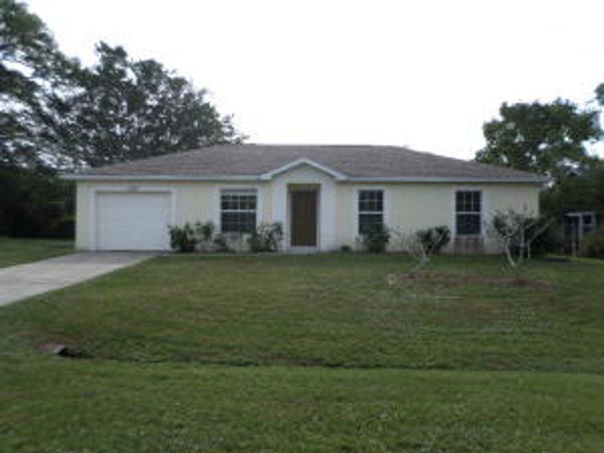 Traditional home sits on a super spacious lot with fully privacy fenced backyard adjoining a lovely wooded area.  Interior offers a great room w/vaulted ceiling, plant ledges, and an eat-in kitchen w/closet pantry, breakfast bar, and sliding glass doors that open to the backyard.  Additional features includes a spacious utility room, hallway linen closet, and 3 cozy bedrooms including a master suite w/a full bathroom and walk-in closet.  This is a terrific first home or something to downsize to! Terrific location just blocks from the Turnpike, St. Lucie West K-8 and Centennial High schools, Oak Hammock Park, the Crosstown Pkwy, and I-95.