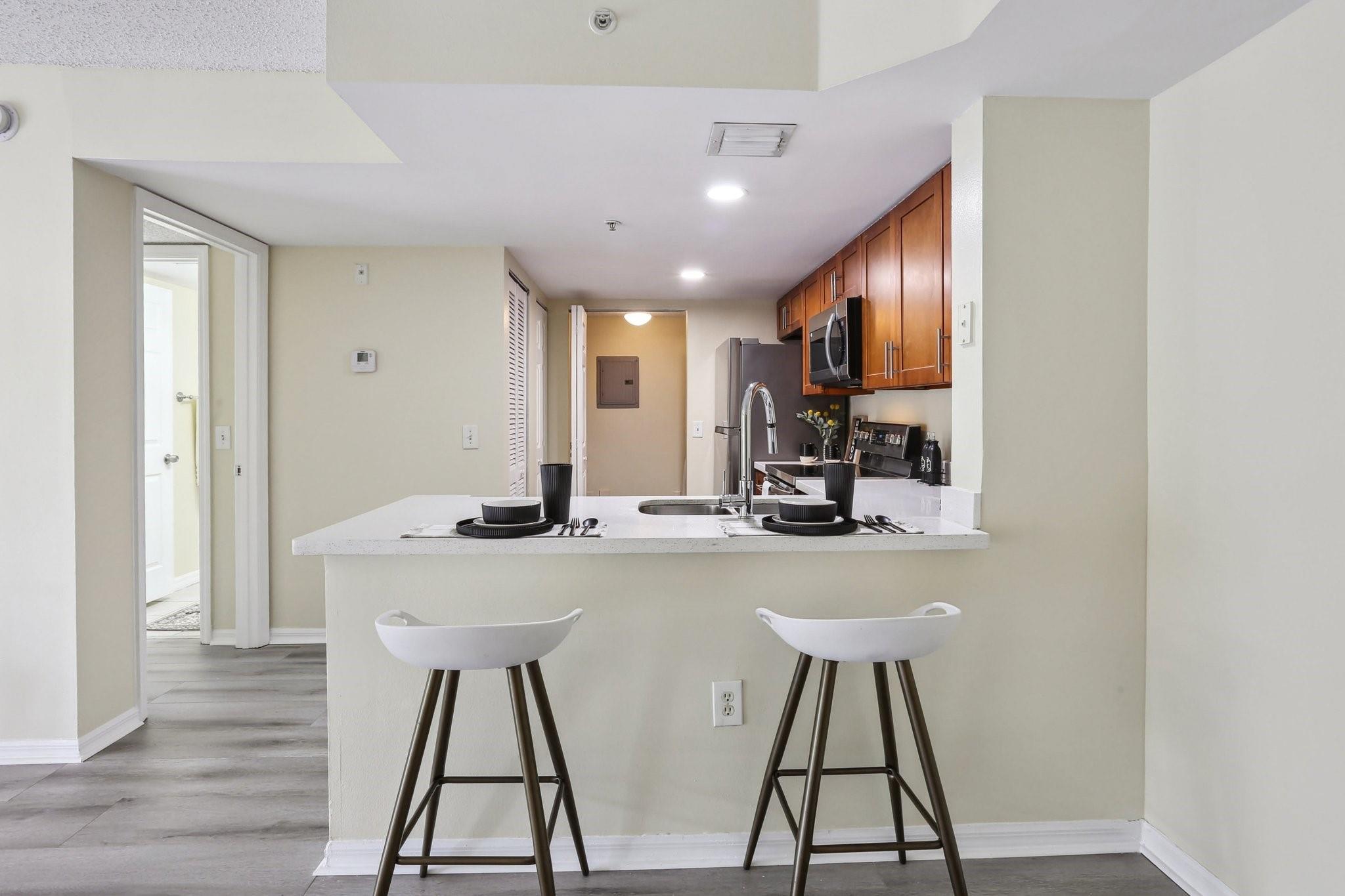Welcome to your future retreat in the sought-after gated community at Evergreen Lakes in Coconut Creek! This second-floor, 2-bedroom, 2-bath home offers comfortable and convenient living. Enjoy an open-concept living area, an updated kitchen, stainless steel appliances, and new laminate flooring throughout. The split bedroom plan includes a primary walk-in closet, in-unit washer/dryer, balcony, and extra storage. New Roof! This gated community features a sparkling pool with lakefront views, sidewalks, BBQ and picnic tables, fitness center, tennis courts, playground, car washing station, and ample guests parking, all just moments from the Promenade's shops, restaurants, and movie theater. Discover all that Coconut Creek has to offer!