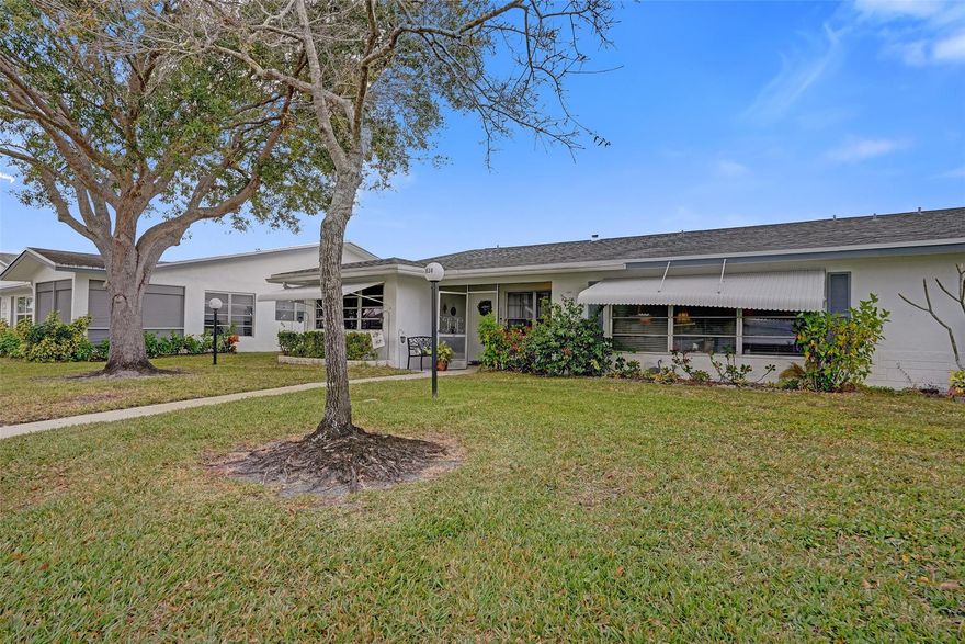 This spacious, beautifully updated villa offers modern living within a charming 4-plex layout. The home features sleek tile flooring throughout and a gourmet kitchen boasting granite countertops with a dual-access design for easy access. Both bathrooms have been custom-renovated with high-end finishes. The primary suite is a true retreat, featuring an adjacent air-conditioned flex space—perfect for a home office or private sitting room. Complete with a large laundry room featuring a utility tub and full-sized appliances, this home combines style with everyday convenience.