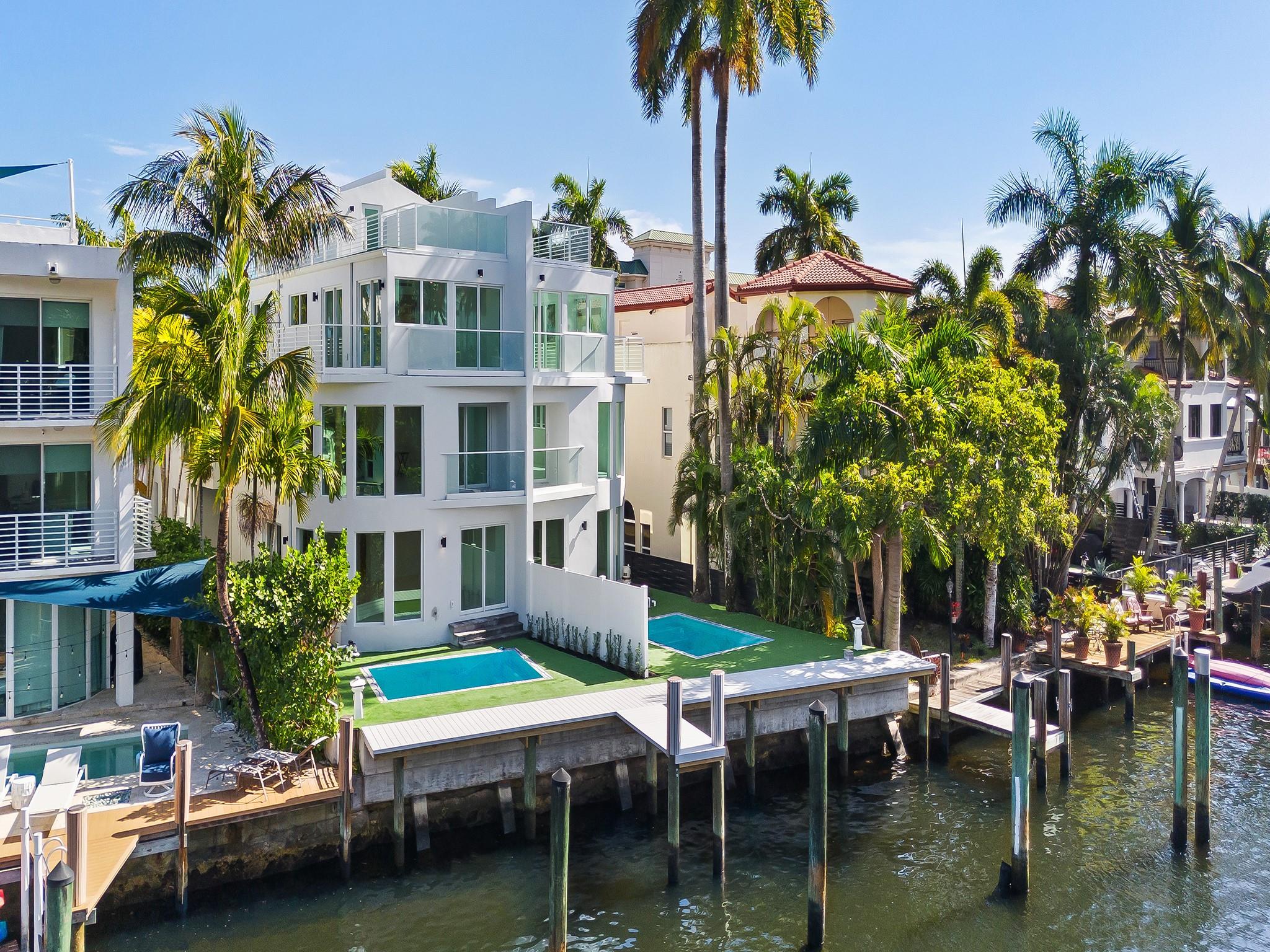 NEW WATERFRONT TOWNHOME situated in Ft. Lauderdale's Las Olas Isles. Contemporary design, modern conveniences, deep water dockage & no fixed bridges to the ocean. A luminous flr plan, flr to ceiling walls of glass & open concept living spaces. Access flrs 1-3 in a glass elevator or by the floating staircase & glass railing. The 1st flr offers a waterside great rm (or optional bedrm) a wet bar, full bathrm & access to a lrg pool & dockage for a 30' vessel. The 2nd flr boasts an open kitchen, a gas cooktop & upgraded appliances, dining area, family room & VIP ensuite bedrm. The 3rd flr waterside primary bedrm w/a lavish bathrm & 4th bedrm w/a pvt. bathrm share a large open balcony. The roof top terrace is outfitted for a future summer kitchen, jacuzzi & generator. Sq ft from developer.