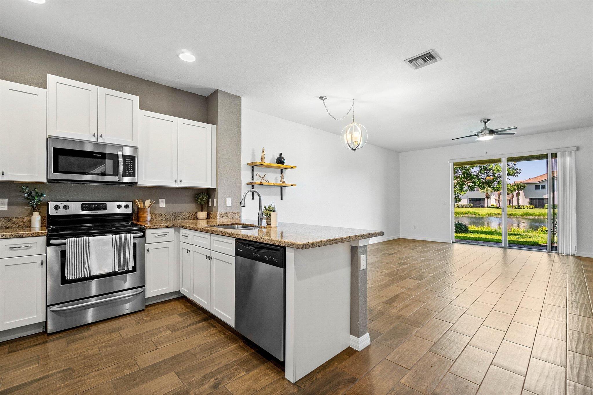 Welcome to this stylish waterfront home, built by D.R. Horton in 2017! This residence combines modern design with move-in-ready comfort! The upgraded kitchen boasts sleek finishes and stainless steel appliances, opening to a bright living area with wood-look porcelain tile floors and abundant natural light. The primary suite offers a fully renovated bathroom with a walk-in shower, designer tile, and premium fixtures. All bedrooms are generously sized with ample storage, and the in-unit washer and dryer add everyday convenience. Step outside to a private patio with tranquil water and fountain views, perfect for relaxing or entertaining. Ideally located near shopping, dining, and major highways, this home blends style, low-maintenance living, and a desirable waterfront lifestyle!