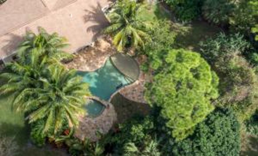 Private tropical oasis on lushly landscaped half acre lot, the home features 3 bedrooms, 2 baths, 2 car garage concrete block single-family pool home located in the highly desirable community of Whispering Trails!  Renovated and updated Single story home with Great open floor plan with vaulted ceilings and a fireplace.  Bright light kitchen with white wooden cabinets, granite counters tops & backsplash & beautiful wood flooring.  This beautiful home features French doors, plantation shutters throughout, wood flooring, outdoor pergola sitting area.  A separate Living Room can be converted into an office or another room.  Both baths have been remodeled to include double vanity with granite countertops and all new tile shower / tub with saturnia marble and/or /frameless shower, newer fixtures