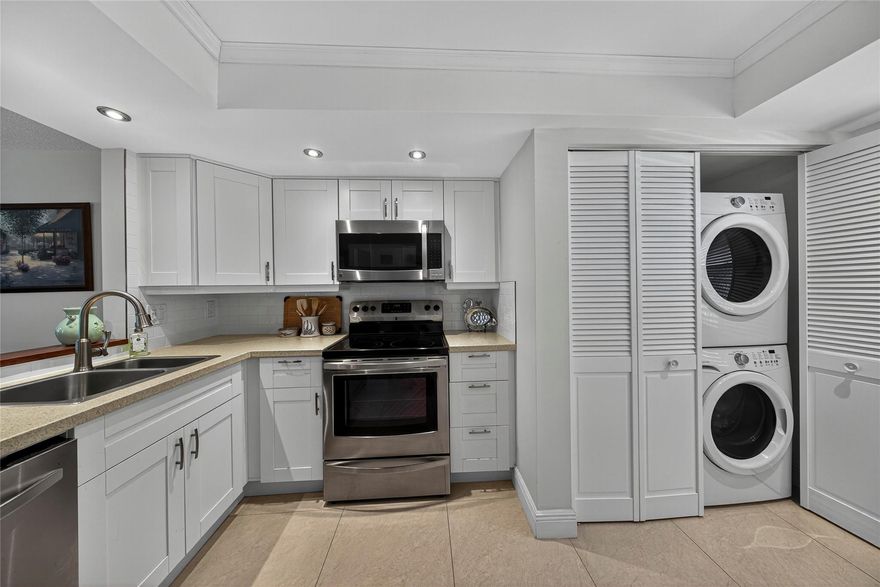 Enter and go "Ahhhh" I'm home.  Beautifully updated 2BR/2BA condo with serene, screened balcony on water.  Neutral tile flooring throughout.  A/C 2025.  HWH 2024.  Impact windows and doors (except entry).  Washer/Dryer in unit.  55+ community has 2 pools, clubhouse has fitness room, billiards room, community/theater room, and so much more.  No lease for 2 years.  New roof and elevator October 2025.  No new assessments planned for 2026.  The association passed the 40-year inspection 2024.  New pavers at the pool.  Clubhouse and pool directly across from the building.  Partially furnished.