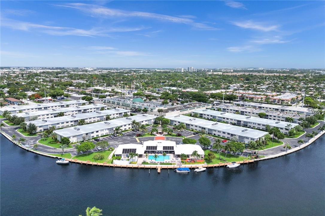 Welcome to your Dream Waterfront Oasis! This 2 Bedroom, 2 Bathroom CORNER UNIT offers a perfect blend of luxury, convenience, and peace. As you walk in the main door it features an open concept plan! Kitchen has Granite Counters along with wooden cabinets and stainless steel appliances and ample storage space. The primary bedroom features a combo tub/shower along with a walk in closet. WASHER & DRYER IN UNIT. New Hurricane Impact Windows, & an upgraded HVAC system. The community provides boat dockage through the HOA, perfect for boaters and water enthusiasts. Community also includes a pool, grilling areas, exercise room, & clubhouse. The unit has 1 deeded parking spot and ample guest parking.