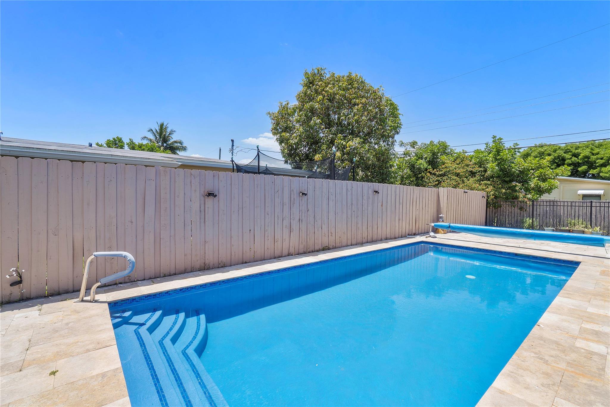 This charming 3 BR/2 BA home in heart of Davie with NO HOA features a large primary bedroom with walk in closet and has separate entrance for 3rd bedroom that could be used as MIL suite or rental unit. Updates (2022): AC & Duct Work, Impact Windows, Plumbing, Roof, Interior Doors, Trim, Ceiling Fans, Granite Kitchen Counters & Backsplash, Painted Kitchen Cabinets, All Appliances & Water Heater, Utility Room/Pantry, Exterior Gate & Metal Privacy Fence, Patio Pavers, Artificial Turf, Pergola, Salt Water Pool with Hawaiian Blue Resurface, Travertine, Pool Pump & Heater, Bathroom Shower Floor Tiles, Paint, Soffit & Facia Board, Seamless Rain Gutters. Non tent termite treatment with yearly renewal paid for. Property is close to universities, Bergeron Rodeo grounds, and Seminole Hard Rock.