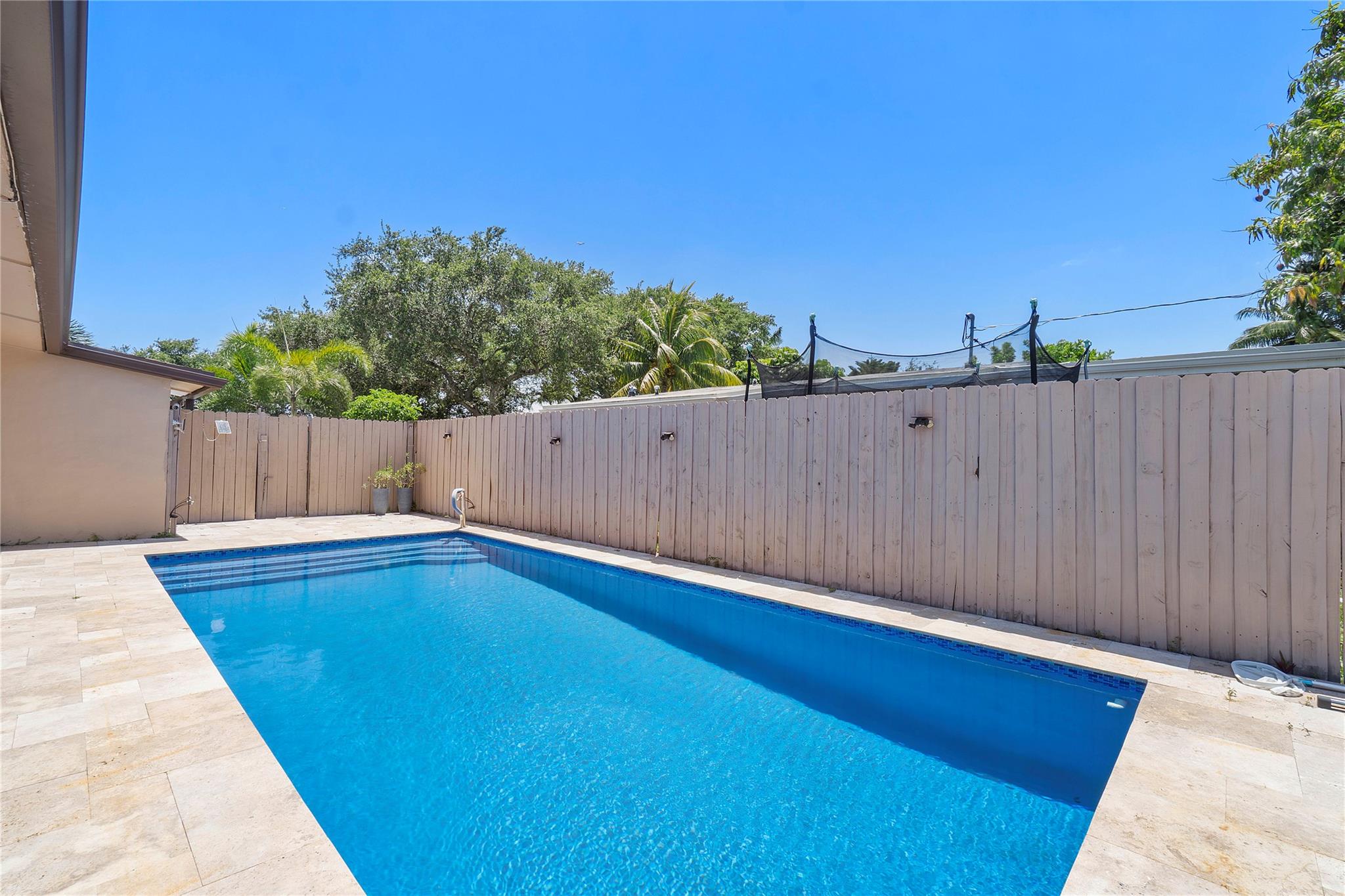 This charming 3 BR/2 BA home in heart of Davie with NO HOA features a large primary bedroom with walk in closet and has separate entrance for 3rd bedroom that could be used as MIL suite. Updates (2022): AC & Duct Work, Impact Windows, Plumbing, Roof, Interior Doors, Trim, Ceiling Fans, Granite Kitchen Counters & Backsplash, Painted Kitchen Cabinets, All Appliances & Water Heater, Utility Room/Pantry, Exterior Gate & Metal Privacy Fence, Patio Pavers, Artificial Turf, Pergola, Salt Water Pool with Hawaiian Blue Resurface, Travertine, Pool Pump & Heater, Bathroom Shower Floor Tiles, Paint, Soffit & Facia Board, Seamless Rain Gutters. Non tent termite treatment with yearly renewal paid for. Property is very close to the universities, Bergeron Rodeo grounds, and Seminole Hard Rock.