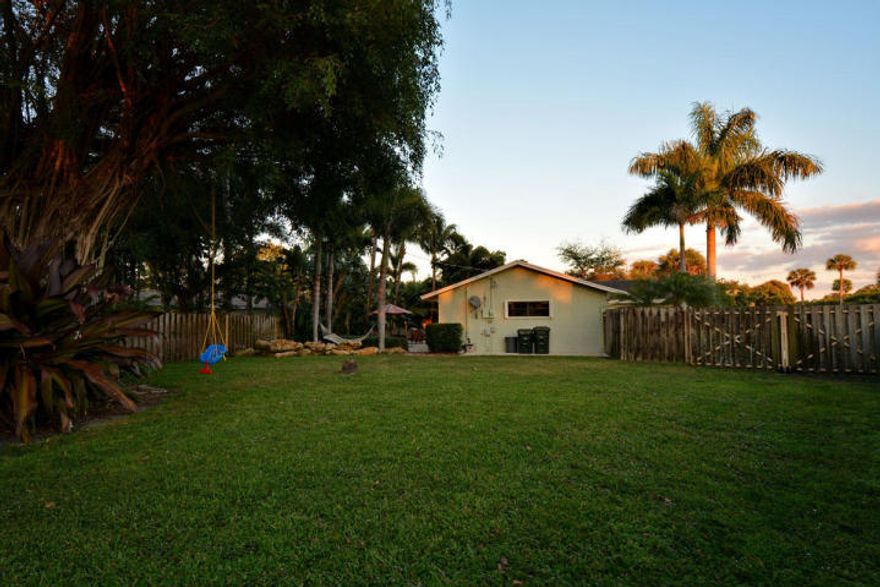 Charming updated home, huge fenced in yard, tropical paradise!  The school district includes Addison Mizner Elementary, Boca Middle and Boca High school. This home is situated in a friendly community with an award-winning school system.