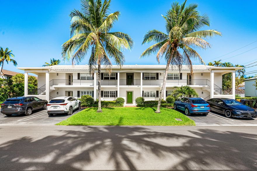 A rare offering in the heart of Delray Beach, this fully gut-renovated 2-bedroom, 2-bath residence blends European sophistication with effortless coastal living. Never occupied since completion, the home is completely move-in ready and positioned just one block from the Atlantic Ocean and three blocks from Atlantic Avenue's renowned dining, shopping, and nightlife.  Located within an intimate six-unit building, this property offers privacy, low HOA fees, and the charm of a boutique residence rather than a large condominium complex. Included are two dedicated parking spaces—an exceptional convenience in this coveted beachside neighborhood.  Inside, every detail has been reimagined. The unit was taken down to the walls and rebuilt with all-new plumbing, electrical, finishes, and impact glass The former enclosed layout has been transformed into a bright open-concept living space centered around a designer chef's kitchen featuring Bosch stainless steel appliances, RO water filter, two refrigerator drawers individually temperature programmable,custome cabinetry, artisan navy tile backsplash, oversized quartzite island, pendant lighting, and wide-plank porcelain flooring throughout.  The primary suite is a private retreat with blackout shades, custom drapery, a walk-in closet, and a spa-inspired en-suite bath featuring European Duravit fixtures, floating vanity, LED medicine cabinet, frameless shower, and striking porcelain tile.  The second bedroom offers exceptional flexibility with its own full bath and a permitted concealed LG washer/dryer, making it ideal for guests, office use, or seasonal living.  A unique standout feature is the expansive 240sf patio—an outdoor living room large enough for dining, lounging, and daily enjoyment, surrounded by lush landscaping for privacy. Morning coffee, evening cocktails, and seamless indoor-outdoor living await.  This is a rare chance to own a turnkey beach retreat with designer finishes, modern systems, private outdoor space, and an unbeatable Delray Beach location.