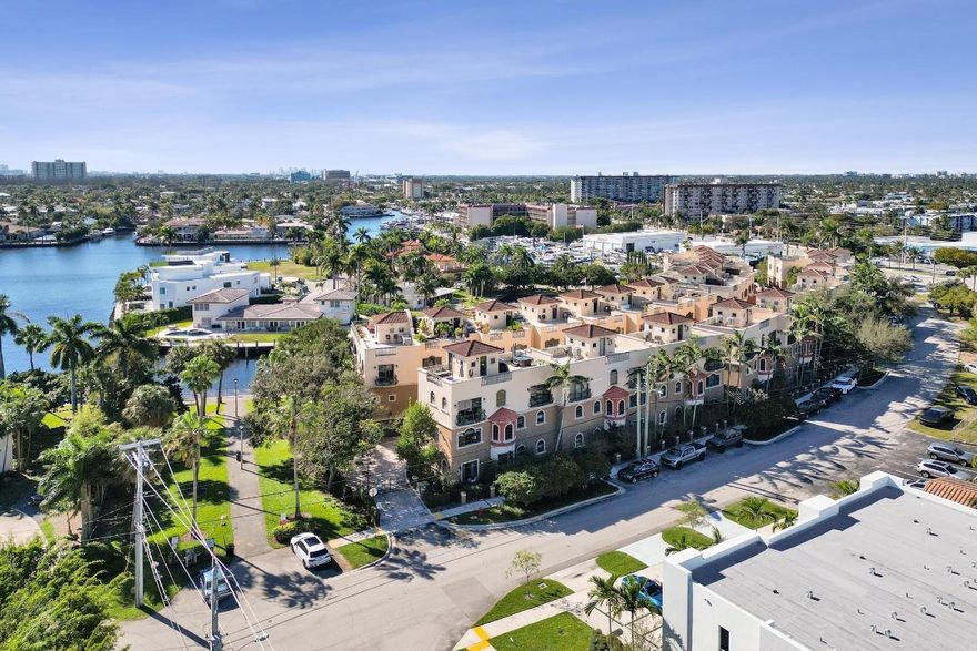 Designed for true boaters, this exceptional 3-bed|3.5-bath corner-unit townhome offers a private boat slip, 32-ft dock, ocean access – NO FIXED BRIDGES. Three impeccably designed levels with private elevator, two-car garage, expansive open-concept living areas, exquisite high-end finishes throughout. The stunning rooftop terrace offers sweeping Intracoastal views and private hot tub—idyllic setting for sunset soirées or relaxation. Expansive windows flood the home with natural light. The elegant primary suite presents a serene retreat with spa-inspired bath & custom walk-in closet. A chef-inspired kitchen combines style and practicality. Ideally located minutes from beaches, dining, shopping, top marinas, this rare offering captures the essence of South Florida’s luxury boating lifestyle.