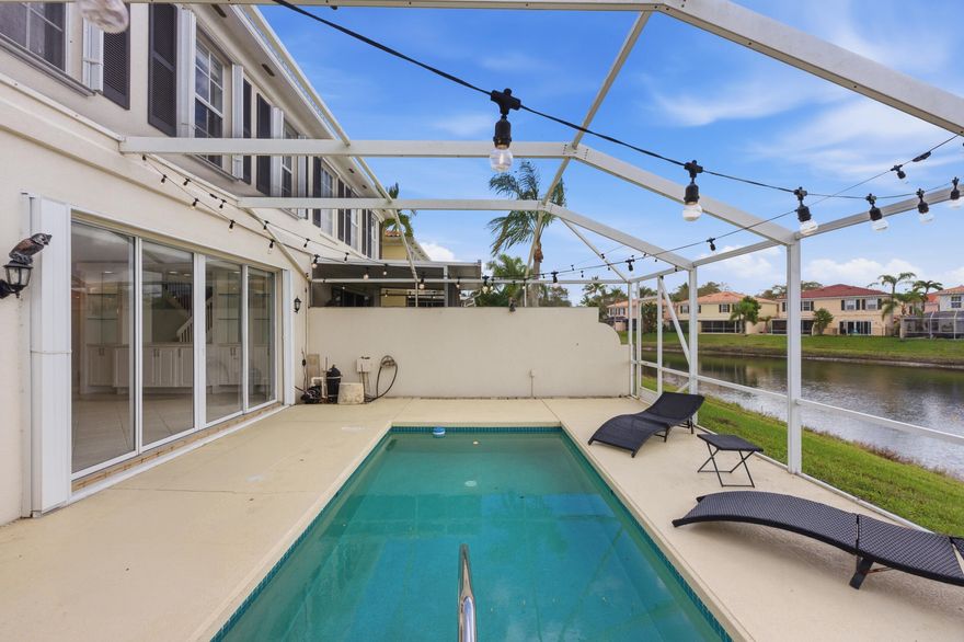 Welcome home to this freshly painted three bedroom, two and a half bathroom townhome with a one car garage and private lakefront pool, located in the desirable gated community of Riverwalk.

As you approach the home, you'll immediately notice the meticulously maintained grounds and beautiful landscaping that make Riverwalk such a sought-after neighborhood.

Step inside and you're welcomed by diagonally laid tile flooring that flows throughout the main living area. The spacious living room features custom built-ins and large sliding glass doors that open to your own private screened-in pool overlooking the lake, creating the perfect space for both relaxing and entertaining. The dining area sits just off the living room and is highlighted by an updated light fixture and decorative ceilin ceiling detail.

The kitchen offers an abundance of counter space and features durable countertops, solid wood shaker cabinetry with updated hardware, dual sink with disposal and filtered water spout, recessed lighting, and bar top seating accented by updated pendant lighting.

Just off the kitchen is a dedicated laundry room complete with solid wood shaker cabinetry, a folding area, and a convenient half bathroom.

Upstairs, the primary suite features wood look laminate flooring, updated trim and fixtures, and an abundance of natural light with views overlooking the private pool and lake. The suite includes dual closets, one being a walk-in, both with built-ins for added organization. The primary bathroom offers a dual sink vanity with solid wood cabinetry and upgraded hardware, a Roman soaking tub, and a fully tiled walk-in shower with a frameless glass enclosure and recessed lighting.

Both secondary bedrooms are generously sized and continue the wood look laminate flooring. Each includes built-ins within the closets and plenty of natural light. The secondary bathroom features an oversized vanity with solid wood cabinetry and updated hardware along with a fully tiled shower and tub combination.

Step outside to your own private screened-in pool overlooking the tranquil lakes of Riverwalk, complete with privacy walls on both sides and plenty of space to entertain. It truly is one of the highlights of the home.

Riverwalk offers luxury, resort-style living without extravagant country club fees. Residents can play tennis or pickleball, meet friends for lunch or dinner, enjoy walking, running, or cycling along 12 miles of pedestrian bridges and pathways, take a quick swim, or work out in the fitness center or lap pool, all exclusively for RiverWalk residents. At the heart of the community is the Town Center, which features three heated pools, a fitness center, and a Sports Center with eight lighted Har-Tru courts, including six tennis courts and two converted into four pickleball courts. The Town Center also offers meeting and activities rooms, a café restaurant, post office, and hair salon, allowing everyday tasks to be completed within the privacy of this gated community.