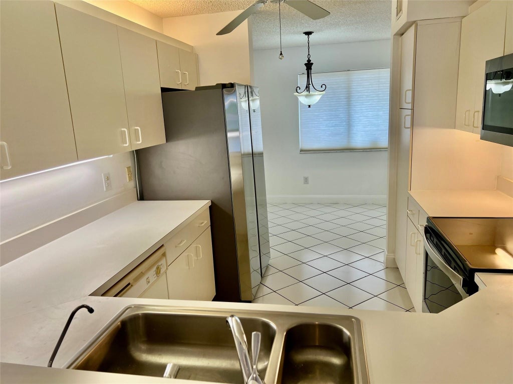 Photo of 9587 Weldon Circle #204, Tamarac, FL 33321 (MLS # F10456705)