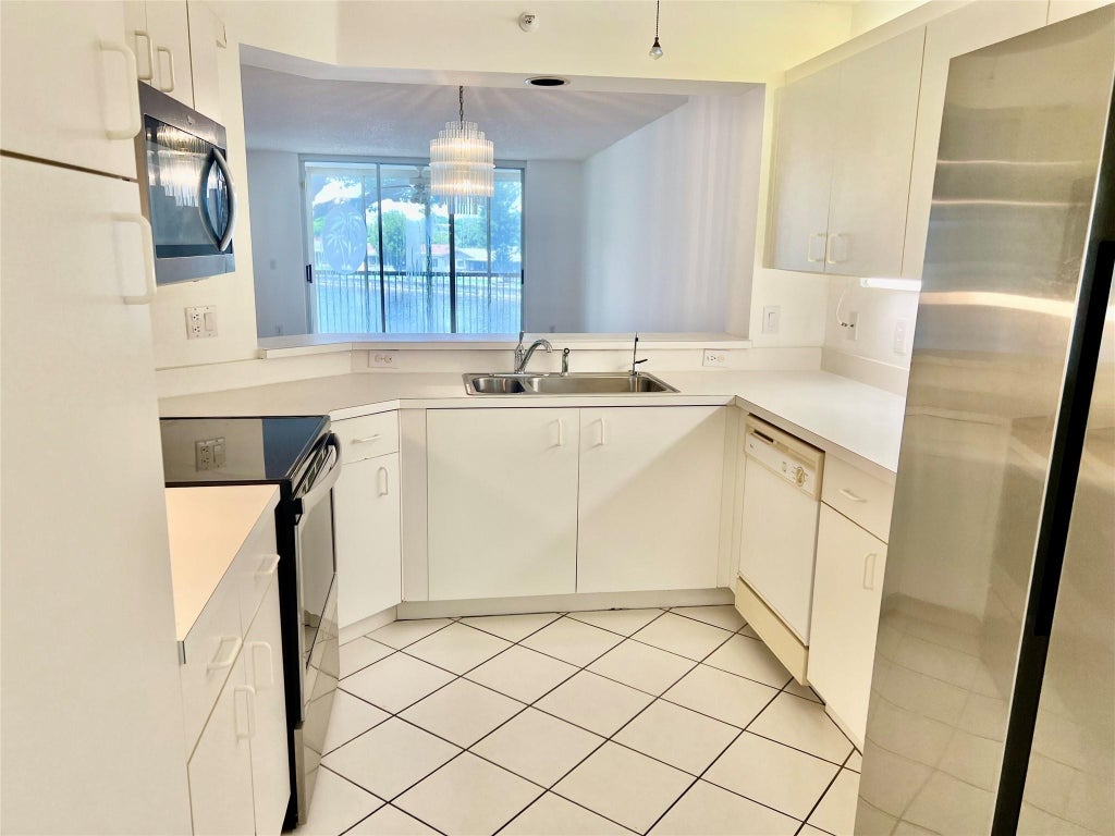 Photo of 9587 Weldon Circle #204, Tamarac, FL 33321 (MLS # F10456705)