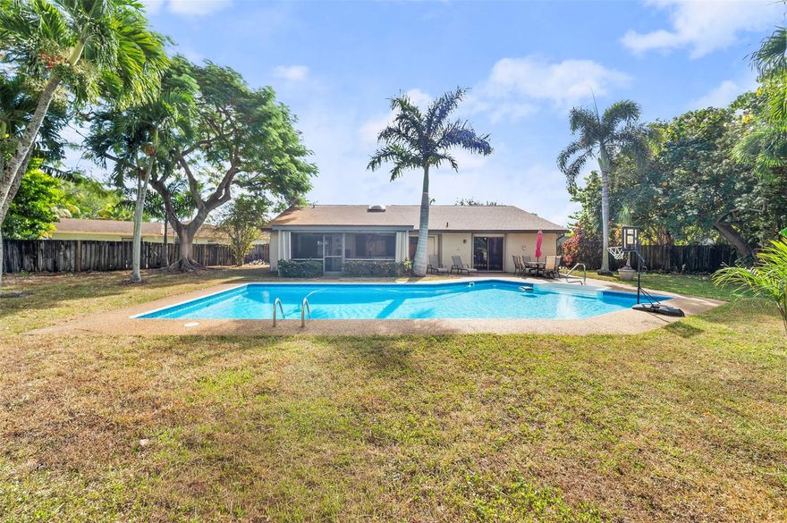 Must see! Incredible 3-br, 2-ba one-story pool home perfectly nestled on an oversized cul-de-sac lot with a fenced backyard and large pool. Beautiful vinyl flooring throughout and vaulted ceilings create a bright, spacious feel. The kitchen features granite countertops, wood cabinets, snack bar, SS appliances, and a cozy breakfast area that opens to the family room. Enjoy year-round outdoor living with a screened patio and large open pool area designed for gatherings. Additional upgrades include accordion storm shutters on all windows, doors, AND the screened patio, a NEW ROOF (Nov 2024), and a hurricane-rated garage door on the 2-car garage. Located in a quiet, desirable community minutes from shopping, dining, the Sawgrass Expressway, I-595, and FLL Airport. This home truly has it all.