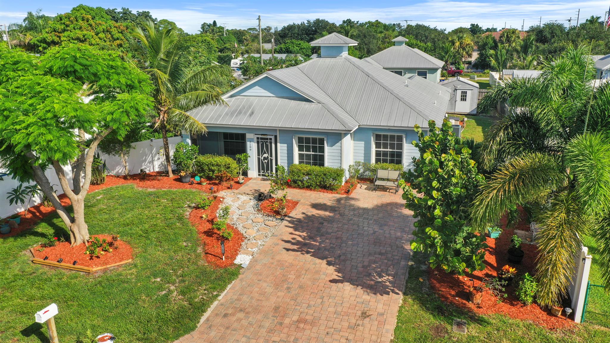 Welcome to this beautifully maintained and freshly painted CBS home, built in 2015 and lovingly cared for by its original owners. Featuring 4 bedrooms and 3 bathrooms, this rare find sits on a spacious 0.21-acre lot filled with lush fruit trees and butterfly-friendly plantings--cherry, olive, avocado, banana, Meyer lemon, and more! Upgrades and peace-of-mind features include a durable metal roof, accordion hurricane shutters (2023), an upgraded A/C system (2021), and a screened front porch (2020). The property also offers a storage shed for added convenience. Located in the desirable Hibiscus Park neighborhood of Stuart, this home combines modern comfort with a vibrant outdoor retreat. Don't miss your chance to own this unique slice of Florida living.