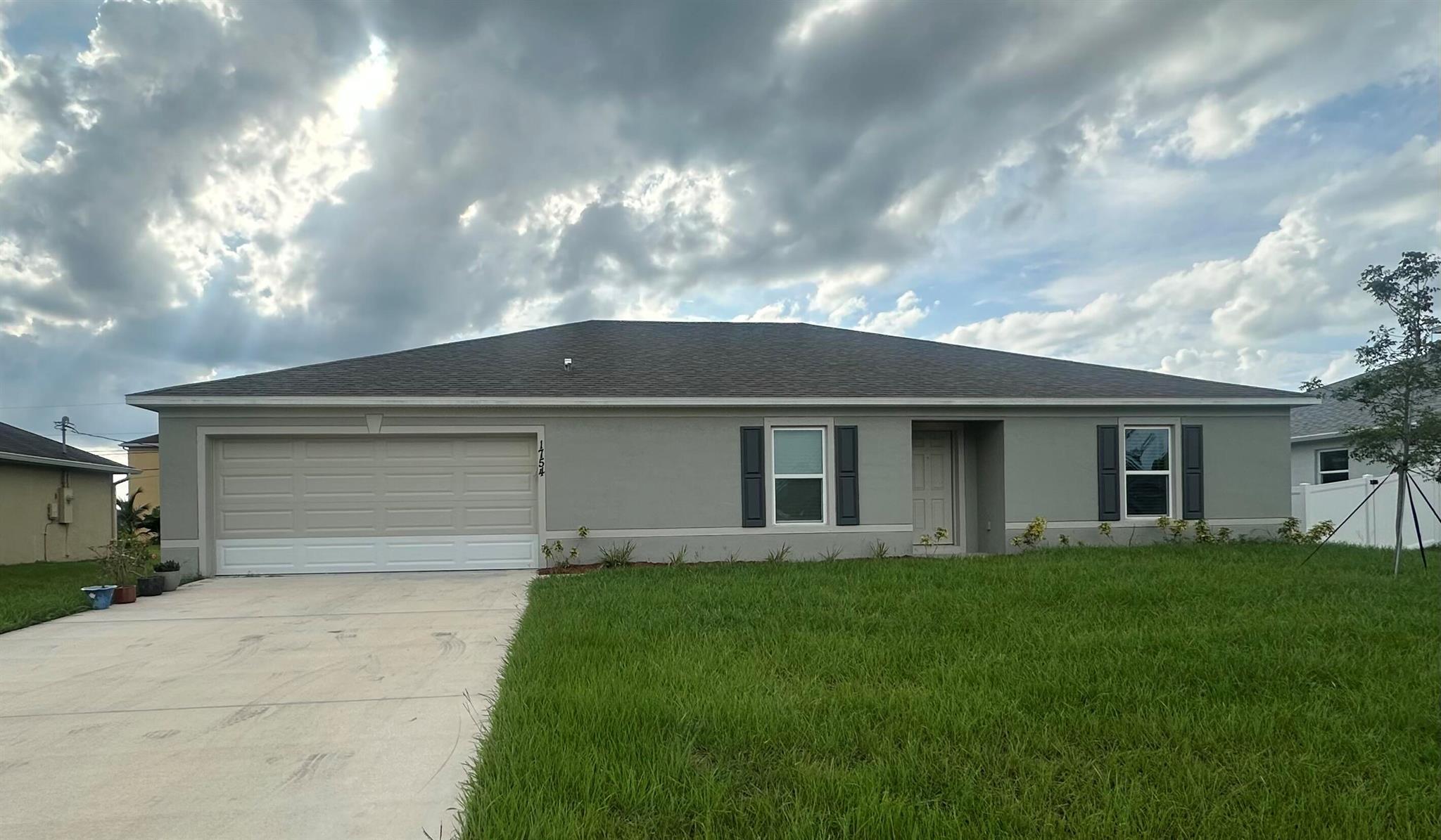 Newly Constructed Home in Port St. Lucie! This property features 4 bedrooms, 2 Bathrooms, plus a Bonus Den/Flex Room could be used as a 5th Bedroom. Newly painted and ready for immediate occupancy! Located close to St. Lucie West and Crosstown Parkway perfect for commuting.