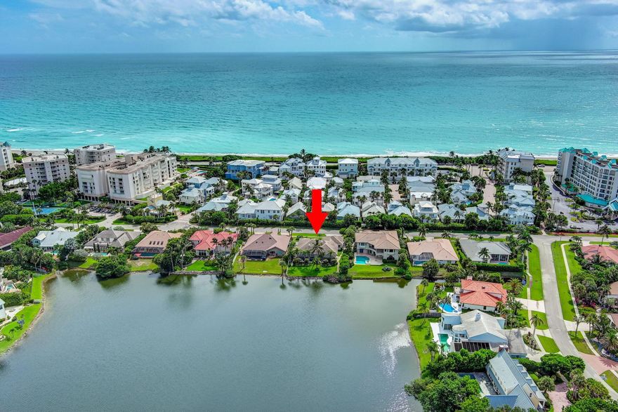 Looking for a concrete block home that is only steps from one of South Florida's most beautiful beaches? Then look no further than this 4 bedroom/3 bath/3 car garage pool home in the sought after seaside community of Olympus.  This one-story home features 2,662 square feet under air and an expansive screened patio overlooking Lake Olympus.  The roof was replaced in 2018 and both AC units were replaced in 2023.  Upon entry you are greeted by a spacious living room with high ceilings and sliders leading out to the back patio.  On your left is the formal dining room which is a great space for dinner parties.  The kitchen, which features double ovens, granite counter tops and tons of cabinets for storage, overlooks the family room which has more sliders leading out to your screened in pool.