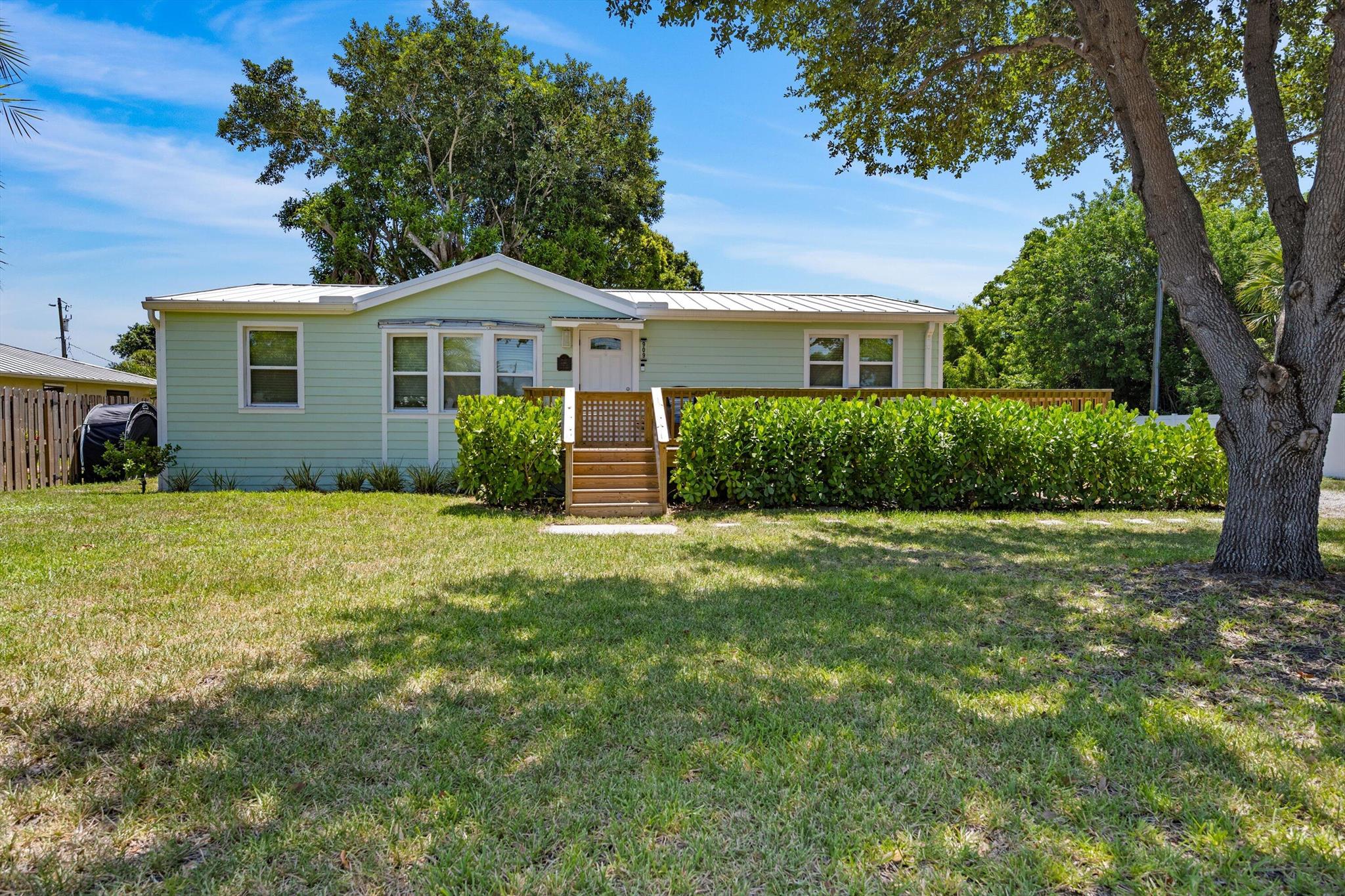 Completely updated and perfectly located, this Stuart home offers the best of Florida living just minutes from Downtown Stuart, beaches, schools, shopping, and dining. Featuring new flooring throughout, a bright new white kitchen with shaker cabinets, quartz countertops, and SS appliances. The home blends style and function effortlessly. Both bathrooms have been tastefully renovated with light, modern finishes, while recent major updates provide peace of mind: new roof (2023), siding and hurricane impact windows (2023), newly constructed deck (2024), new rear paver patio (2023), new exterior and interior paint (2024), front irrigation (2024),and hot water heater (2024). Set on a spacious lot with mature trees, there's plenty of room to relax, play, and entertain outdoors.
