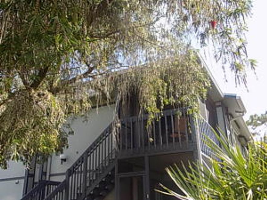 This very spacious upstairs 2 bedroom 2 bath  condo has a skylight with soaring ceilings which add to this bright open space. New bathroom lights and fixtures, new flooring, new fans, new doors and in guest bath new seamless shower. Floor to ceiling bookcase for extra storage and pull out shelves for buffet. Enjoy private setting on the screened porch. One of the few communities that allows trucks, motor cycles and for an investors, no wait to rent. The community also offers a beautiful pool and picnic area and storage for RV's and boat. 1 pet 20 pds and under. Close to the beach, shops, golf and restaurants.All ages welcome. HOA fee covers outside insurance, basic cable, pool and common areas.Florida living at it's best. Being Sold ''As-Is' for the convenience of the owner