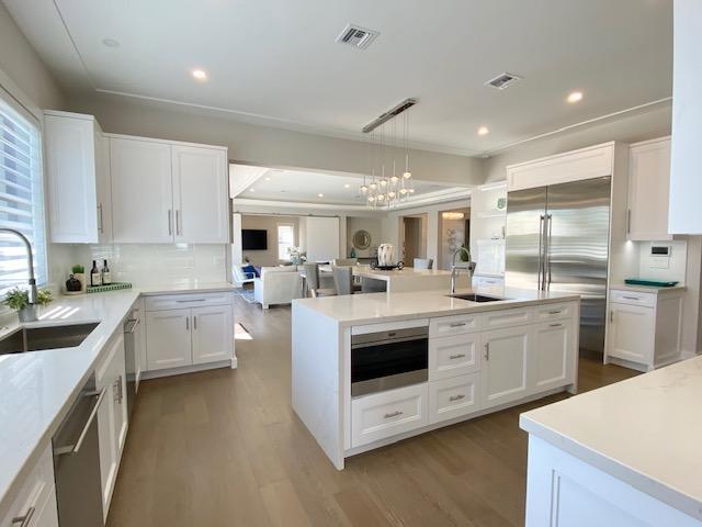 Live in this modern, chic, waterfront oasis in the highly desirable neighborhood of Boca Harbour. This 2019 constructed Southern exposure estate home with an open floor plan features five bedrooms, five full bathrooms, an expansive gourmet kitchen with solid wood cabinets, large island, quartz countertops, Wolf Sub-Zero appliances, and a gas cooktop. All bathrooms have been professionally designed with high-end porcelain and ceramic tile and quartz vanities. Additional interior features include hardwood flooring throughout, level 5 smooth ceilings, recessed LED lighting, CGI impact windows, and doors, casing around all windows, first and second floor laundry rooms, 6' baseboards, & high-end fixtures. All windows have new remote control Silhouette window treatments. High-tech alarm system