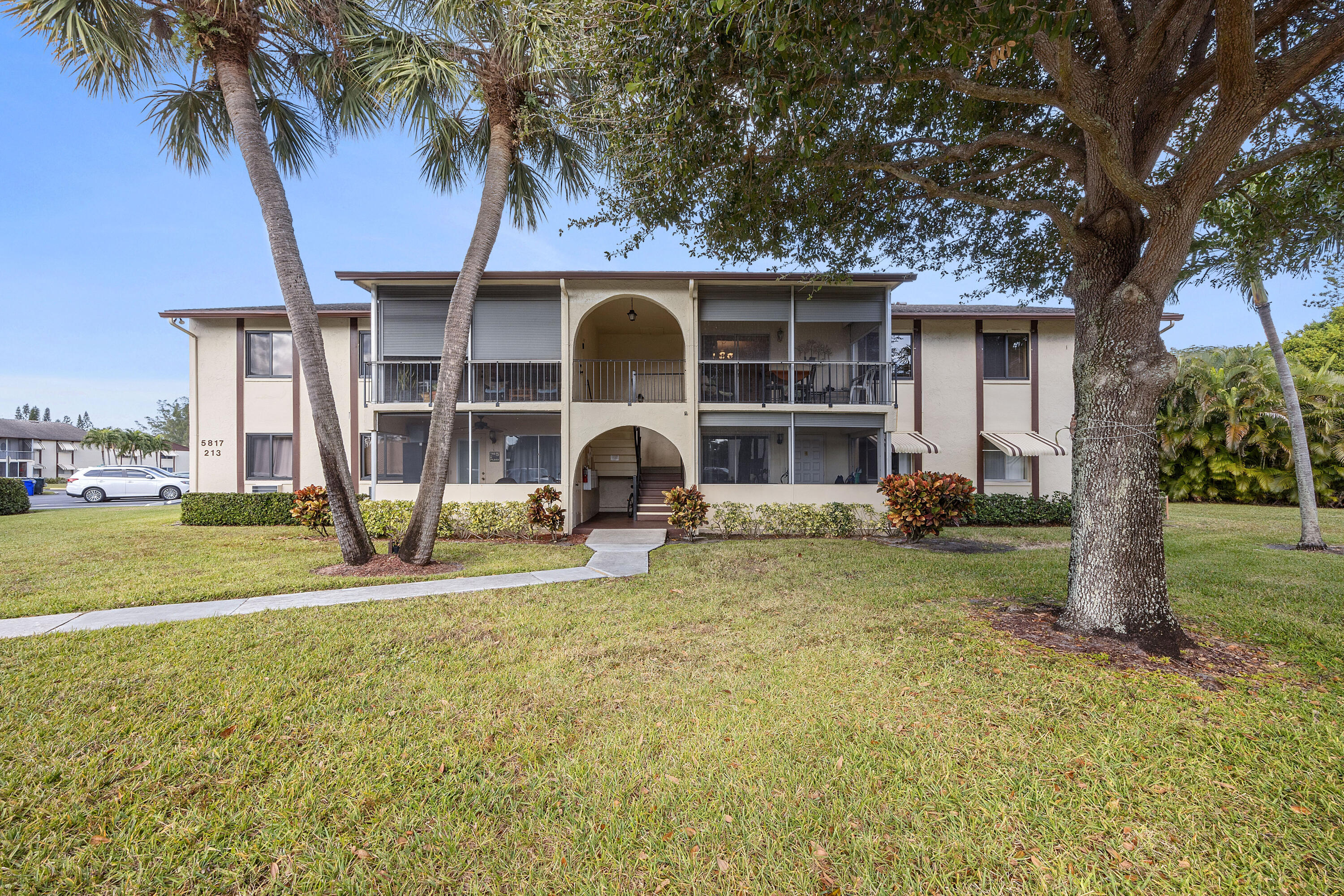 Super clean 2nd floor corner 2 bedroom condo with a great open floor plan! Beautiful laminate flooring in the living areas, tile in kitchen and bath. BRAND NEW WATER HEATER, BRAND NEW ELECTRIC PANEL, HURRICANE IMPACT WINDOWS! Very nice white kitchen with pretty backsplash and a huge pantry. Each bedroom has its own walk-in closet. Updated bathroom. Separate laundry room with full-size washer and dryer. Nice screened porch with roll-down shutters and overlooking a pretty courtyard. SOLD FURNISHED and ready to move-in! La Pinata is a well-maintained 55+ community with clubhouse, pool, bocce, etc... Internet and cable included in the condo fees.