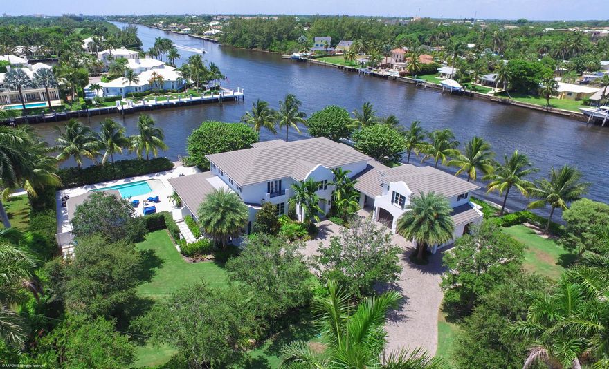 Point Lot Estate Commanding 411 feet of Waterfrontage. Staged against the sparkling Intracoastal this 9,600 total square foot Point Lot Estate is sited on 411 feet of water frontage.  Completely re-designed from top to bottom in 2014 the meticulous finishes and superb craftsmanship are evident in every detail. The home offers 5 bedrooms seven plus baths, a self-contained guest apartment with large living and kitchen area accommodating friends and family with prized private space. Upon arrival guests are greeted with a gracious staircase leading to a magnificent master suite with his/her bathrooms, three additional guest suite, all with water views, plus a workout room. Encompassing the first floor is a lovely living room with fireplace, an oversized dining room and a cozy sitting area.