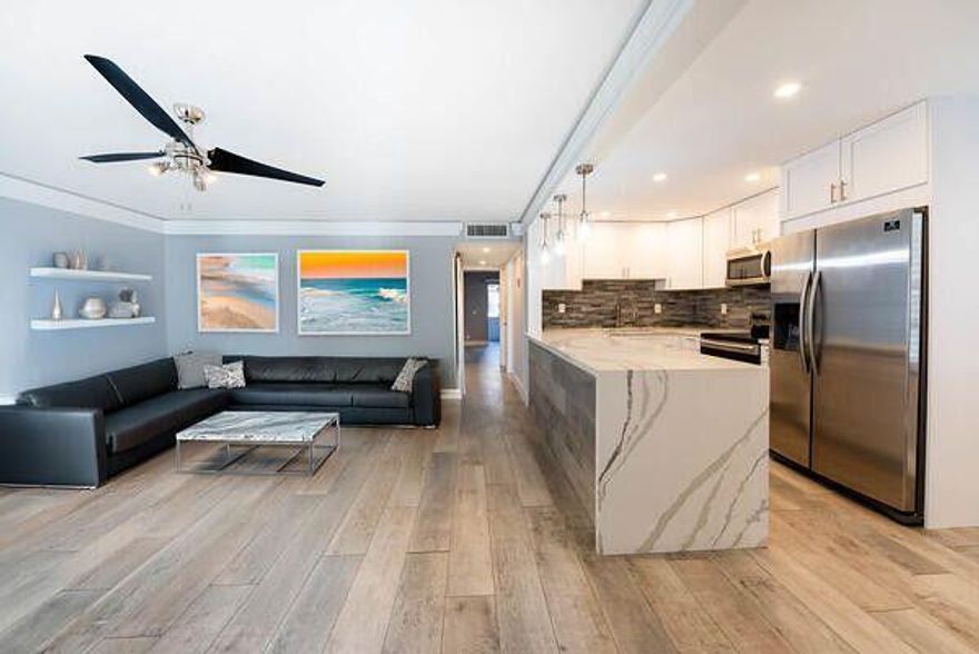 Renovated, 2 bedroom/2 bathroom condo located on the main floor/garden view. Chef's kitchen with custom cabinets Porcelain tile backsplash,Quartz counter-tops with a waterfall edge and top of the line appliances. Enter the luxurious (en Suite) master bedroom through the sliding barn door. The master bathroom has 2 Sinks and 2 vanities!!!shower has a decadent rain head, a frameless glass enclosure and a bench seat!! The living/dining room has ''European crown moulding. The outdoor patio has Porcelain floors with a great garden view attached laundry room has a whirlpool washer and dryer. Very close and convenient to the pool and club hous. Flanders has a newly renivated club house.