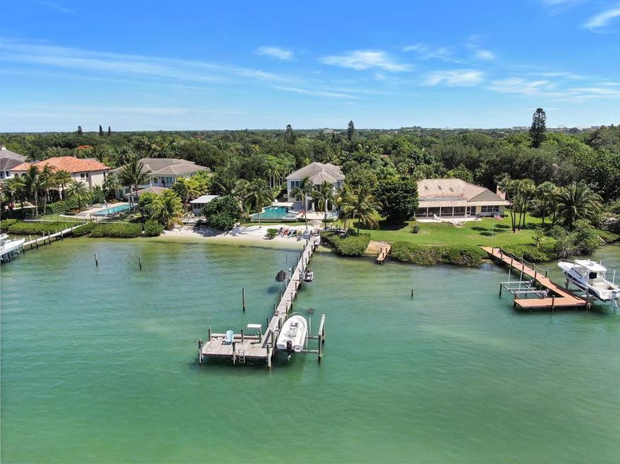Turquoise blue green water becomes your best friend at this magnificent riverfront home with southern exposure. This is one of the most desirable spots on the Loxahatchee River as you are able to sit on your dock and watch the turtles and dolphins swim right by. This two-story residence was redone in 2016 and boasts over 6,400 sq. ft. of living space, which includes 5 bedrooms, 5.2 bathrooms, a mudroom, and a kid's playroom on the 2nd floor. Engineered wood plank flooring throughout, gourmet kitchen, coffered ceilings in the living room, and pecky cypress in the family room. This home features soaring ceilings, solid core doors, a whole house generator, 1,000-gallon propane tank, impact windows and doors, and beautiful craftsmanship throughout. The large kitchen has Calcutta Gold marble honed on the island and backsplash, Sub Zero refrigerator, Thermador gas stove, U-Line wine refrigerator, double pantry and fixtures are Hans Grohe. The master suite boasts beautiful views of the river, walk-in his and her custom closet with built-ins, vanity area, and a spa-like bathroom with a large walk-in shower, dual sinks, White Diamond polished and honed countertops, Kovacs lighting, paperwhite Carrera honed and polished flooring.  Additional features of this home include 1 guest bedroom downstairs and the remaining guest bedrooms upstairs with plantation shutters and built-ins in the closets, marble countertops in the guest bathrooms. The lovely powder room features an Ann Sacks inspired mosaic glass design, 2 tankless hot water heaters, surround sound in the family room and patio area, gas fireplace controlled by a remote, CAT 6 wires in every room, security system, 4" high hats throughout, central vac, electric shades in the living room and bedrooms, and Hammer slate tile in the laundry room.  The residence is immaculate, with no expense spared. 
 
Cool off in the heated salt-water pool, which has 2 new pumps or host a cookout with the outdoor summer kitchen, which features a dishwasher, an Alfresco grill, refrigerator, and 2 TVs.  There is also a dock that features 2 jet ski lifts and a new 10,000-pound boat lift. Whatever you decide to do, this beautiful home is perfect for entertaining and enjoying the outdoor life Jupiter has to offer!