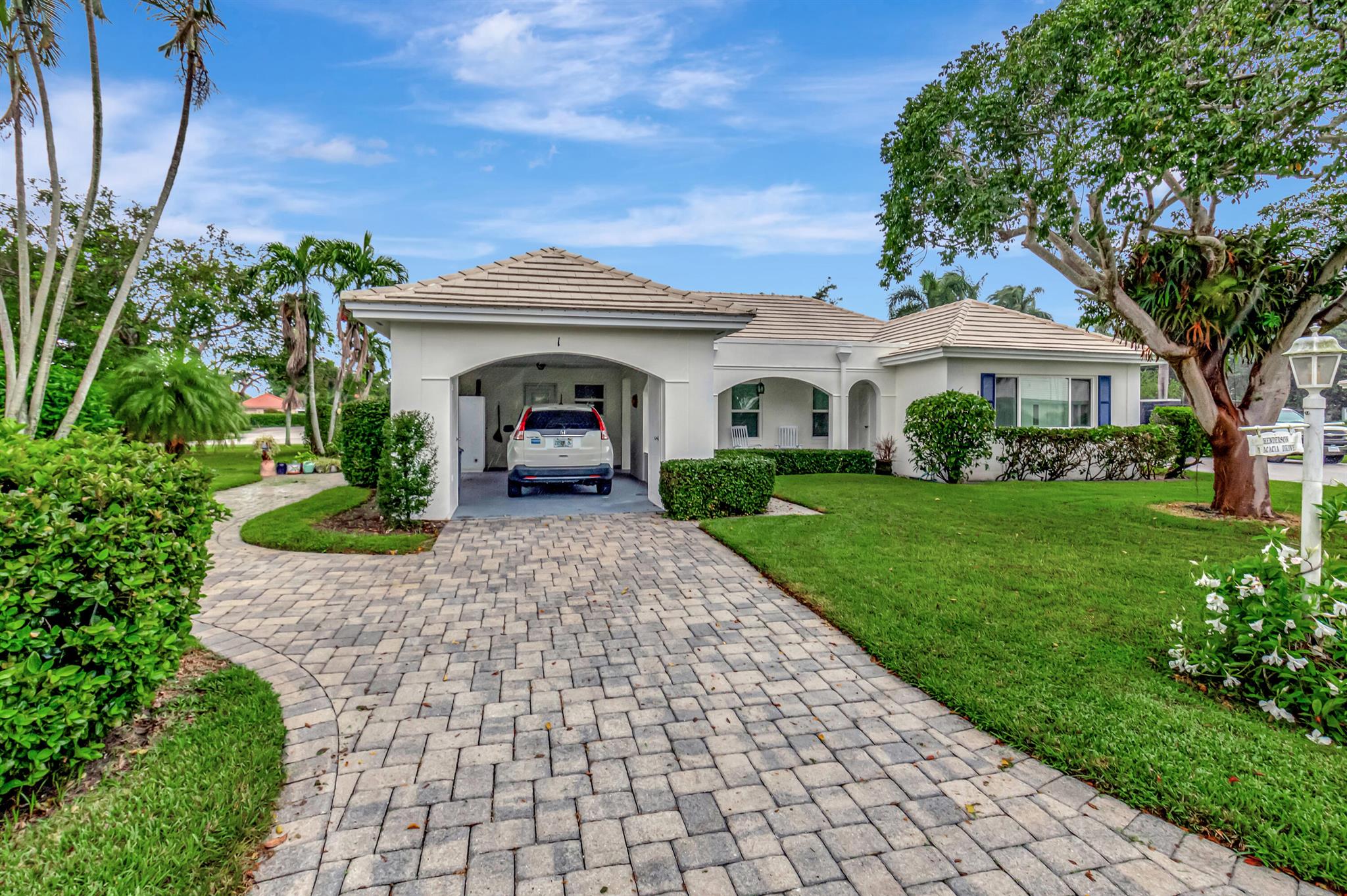 Welcome to beautiful Delray Dunes Golf and Country Club and this fantastic single family home in Acacia Villas, This home features 2 bedrooms, 2 baths, and carport with car and golf cart parking. You will love the nice open floor plan with a large living room plus a large Florida room all overlooking the lovely maintained grounds. Nice front porch with a peaceful garden view. The property has an updated white kitchen, granite counters and stainless appliances.The home has great features including an interior laundry room, hardwood floors in the bedrooms, neutral tile throughout the rest of the home and lots of storage. This sought after model is rarely on the market so hurry! Delray Dunes is a mandatory membership in one ao South Florida's finest country clubs with exceptional amenities