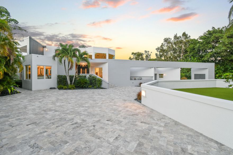 Stunning Newly Renovated CBS Home and Property with a detached Guest House. The home offers timeless architecture paired with luxurious modern living. Situated adjacent to Jonathon Dickinson State Park and next to the Loxahatchee River, providing Extraordinary Views and Sunsets. Elevated high & dry, the house and property are surrounded by a concrete seawall barrier. There is river access through a path behind the house for kayaking, paddle boarding, & water activities. Located just minutes to the Beach & town center. This impeccable residence offers a Large Captivating Heated Salt Water Pool, Built-In Cedar Sauna, Turf Rooftop Decks & Lawn, Expansive Silver Travertine Driveway and Pool Deck with Hardscaping, spacious Covered Lanai, sizableTiki Hut, plus a Private Gated Entry.   5 Bedrooms, 5 Bathrooms of Airy Living Space with Abundant Natural Light. Awe-inspiring Primary Bedroom Suite with an Office and outside shaded deck offers breathtaking views of the River & Park. A Large Private Property with Hiking/Biking trails from your back door access. New Roof, Entrance & Exit Driveway Gates, Porcelain Floors, Hardwood Floors, Tiki Hut, Extensive Landscaping, Hardscape work including Black Polished Stones surrounding the property, Gourmet kitchen, Two dramatic elegant wood burning porcelain fireplaces, Custom Glass staircase railing, Impact Glass windows and Doors, New Oversized Impact Garage Doors, Three car garage w/ finished floor, Large Driveway with ample parking for cars, boats, or RV. Security cameras & Alarm system. No HOA fees and low Martin County taxes. Just minutes to shopping, fine & casual dining, entertainment, and the beach. PBI is 25 minutes away.