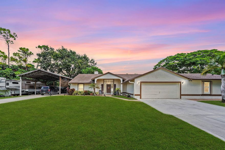 WOW FACTOR ALERT! This is a stunning nearly 1.5 acres.retreat of pure Florida paradise. NO HOA, NEW ROOF & RARE DUAL DRIVEWAYS! The main home offers 3 beds / 2 baths, an airy open layout with vaulted ceilings, and a beautifully UPDATED kitchen with granite counters, subway tile, and rich cabinetry. The primary suite impresses with a custom walk-in closet and spa-like CABANA bath. A remodeled IN-LAW SUITE with its own entrance, full kitchen, and bath makes the perfect guest haven or rental! Outside, enjoy your private oasis POOL & HOT TUB with an OUTDOOR SHOWER, covered/screened patio, + a fully fenced yard with canal access on 2 sides. Extra perks: oversized carport with water/electric (boat/RV ready), functioning fireplace, accordion shutters, and generator hookup. Minutes to everything!