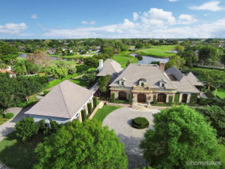 Absolutely unique and extremely private 1.25 manicured acre estate with incomparable Golf course and long lake views. Quietly elegant European style with detailed finishes and imported exotic wood. This 6 bedroom, 6.5 bath home defines luxurious living on a grand scale. From the moment you arrive the spectacular home will captivate you. Indulge casual elegance in the open and spacious family room. No expense has been  spared in the gourmet kitchen fit for a culinary chef, with top-of-the-line appliances and custom wood cabinetry. The kitchen flows past the European style bar into the relaxed, yet elegant family room. Perfect for entertaining, this house has a grand screened patio with a summer kitchen, fireplace, dining, and reading areas all with water views.