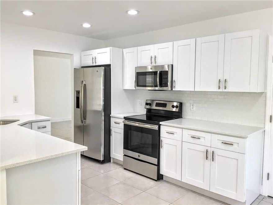 Spacious 2 bedroom, 2 bath home with 1 car garage in Oakland Park. New A/C! Upgraded kitchen with new cabinetry, quartz countertops and stainless steel appliances. Remodeled bathrooms featuring new vanities, fixtures and tile inlay in showers, new laminate wood floors in bedrooms and family room, new interior doors, trim, baseboards, new interior/exterior paint, fenced rear yard.