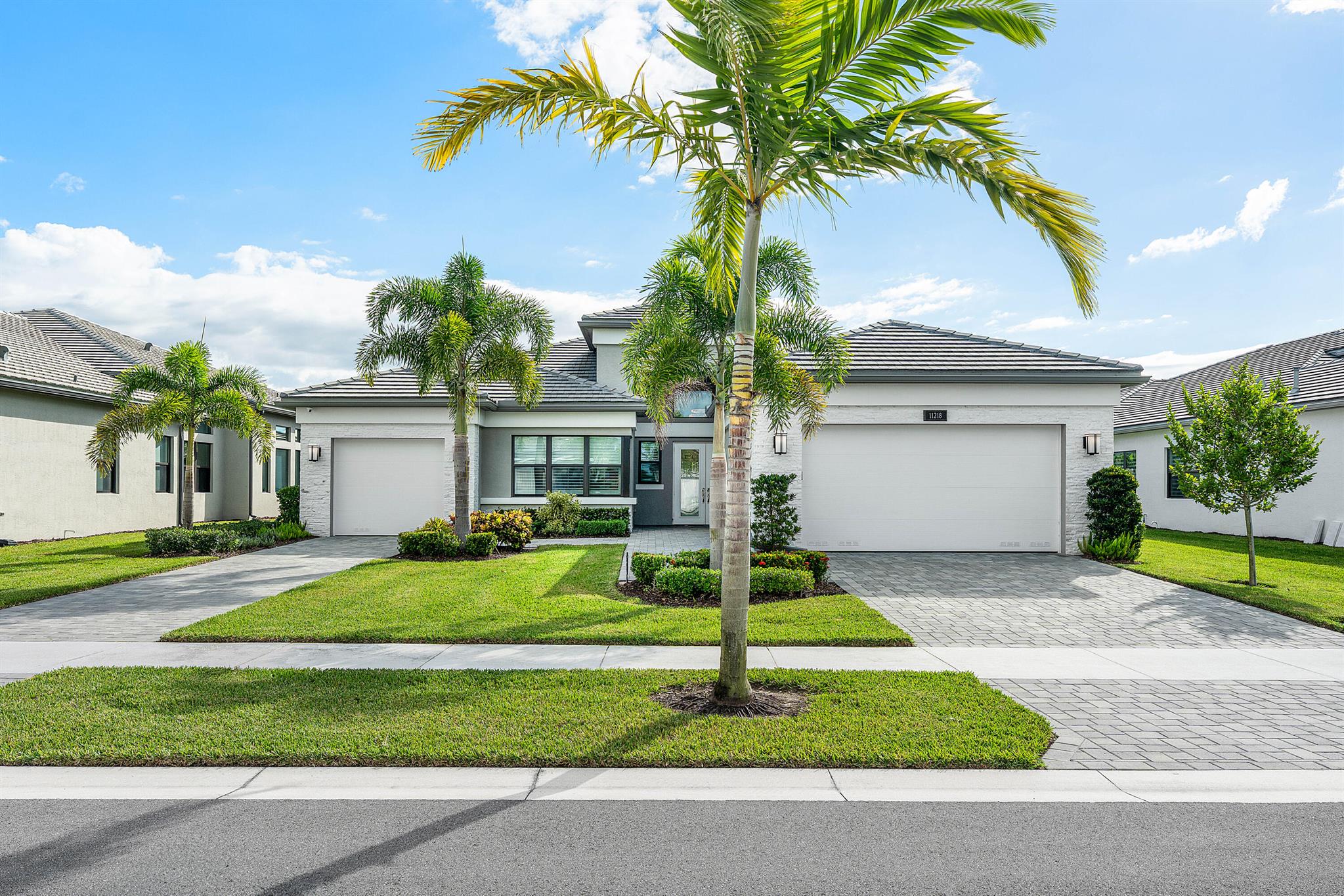 Lushly landscaped Napa model on beautiful lakefront lot. Great curb appeal-stone front, extended walkway and etched glass doors. The open concept home (4/4.1+Club Room+split 3cg) has impact windows, 24'' porcelain tile floors, designer window treatments & light fixtures, LED hi-hats, fans, custom built-ins, outfitted closets, upgraded baths and more! Gourmet kitchen w/gas, white wood cabinetry with banks of drawers and pull-outs, quartz countertops with full height backsplash, stainless hood, center island with pendant lights & more! Dining  room has built-in buffet unit with storage and display. Luxurious primary suite, three ensuite guest bedrooms and formal powder room. A large Club Room has a built-in desk unit. You'll love the screened porch, fenced yard, heated pool and lake view.