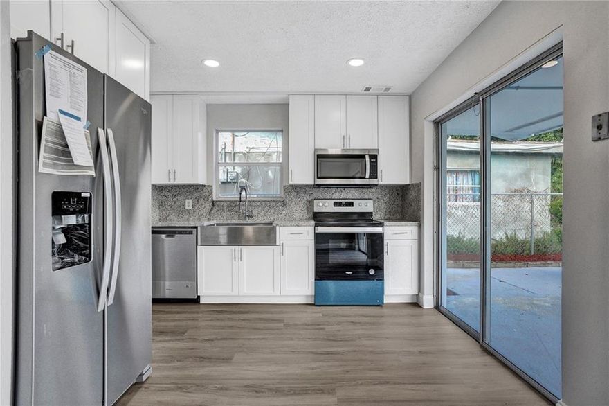 Fully remodeled with new kitchen with white shaker wood cabinets, granite countertops and stainless steel appliances, farmhouse stainless steel sink. Remodeled bathrooms with double sink vanities and frameless showers in Both bathrooms. New waterproof laminate flooring throughout the home. New hot water heater and new full size washer and dryer. Freshly painted inside and out. Roof  2016 and a/c is 2 years old. Newly remarcited POOL with new tile. New extra long driveway.  Hurricane shutters. Huge walk in pantry closet. Close to community boating ramp. Close to beaches,  and downtown Ft. Lauderdale..