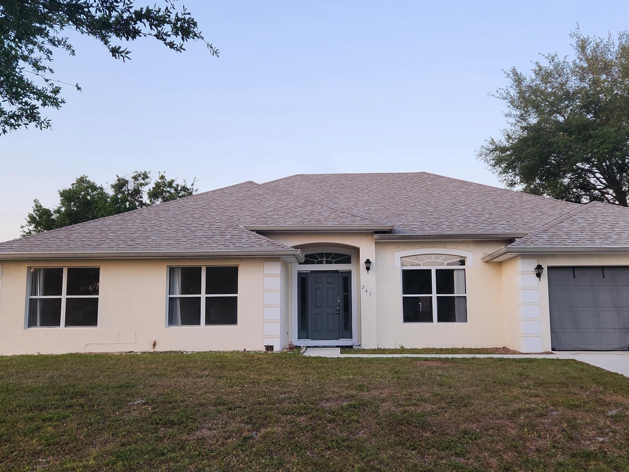 New roof just installed! New pictures coming soon. Welcome to this stunning 3,687 sq. ft. home in the heart of Port St. Lucie. Designed for both comfort and style, this home boasts an open floor plan with soaring vaulted ceilings, creating a bright and airy atmosphere throughout.The expansive living area seamlessly flows into the modern kitchen, perfect for entertaining. Whether you're hosting gatherings or enjoying a quiet evening, this home provides the perfect setting. The generously sized bedrooms offer plenty of space for relaxation, while the primary suite is a true retreat with its own en-suite bath.Located in a desirable neighborhood, this home is just minutes from shopping, dining, and beautiful Florida beaches. Don't miss the opportunity to make this incredible property