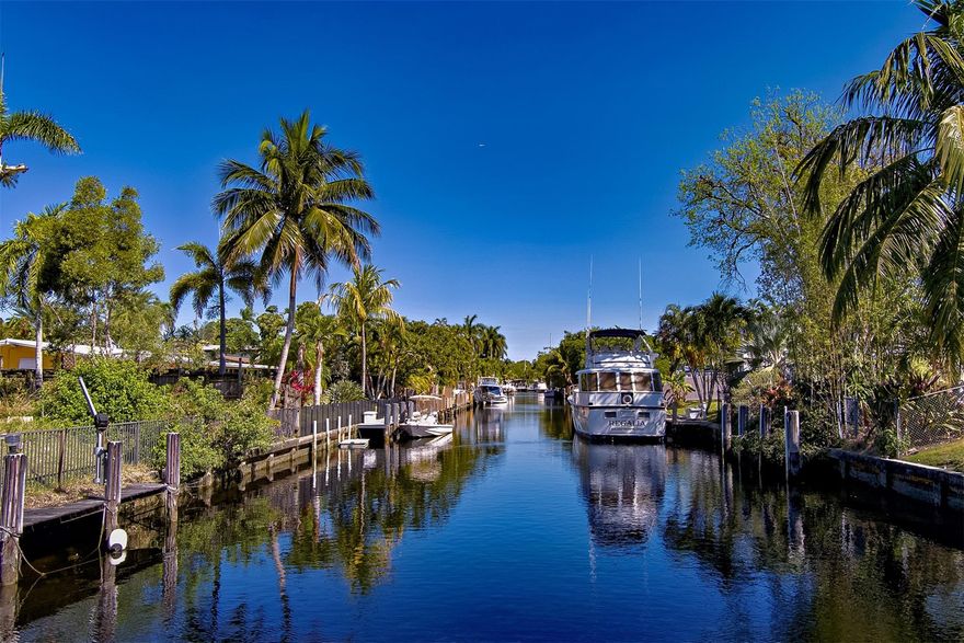 Stunning Waterfront home offering the perfect blend of comfort and convenience! With NO HOA, Ocean Access, and NO Fixed Bridges. This property is a boater's paradise, featuring 65 feet of dock space and mature Coconut and Mango Trees. Inside, you'll find large, sun-filled rooms with windows galore, allowing natural light to fill every corner of this 2300 square-foot, one-story home. Complemented by beautifully landscaped yards using zero-scaping, offering low-maintenance beauty year-round. The kitchen and laundry areas come fully equipped with all appliances, including a new 2024 dishwasher, refrigerator, stove, microwave, and washer/dryer. EcoSmart tankless water heater for energy efficiency.  Recent updates include a new roof ( 2022). Close to major highways, airports, and beaches.